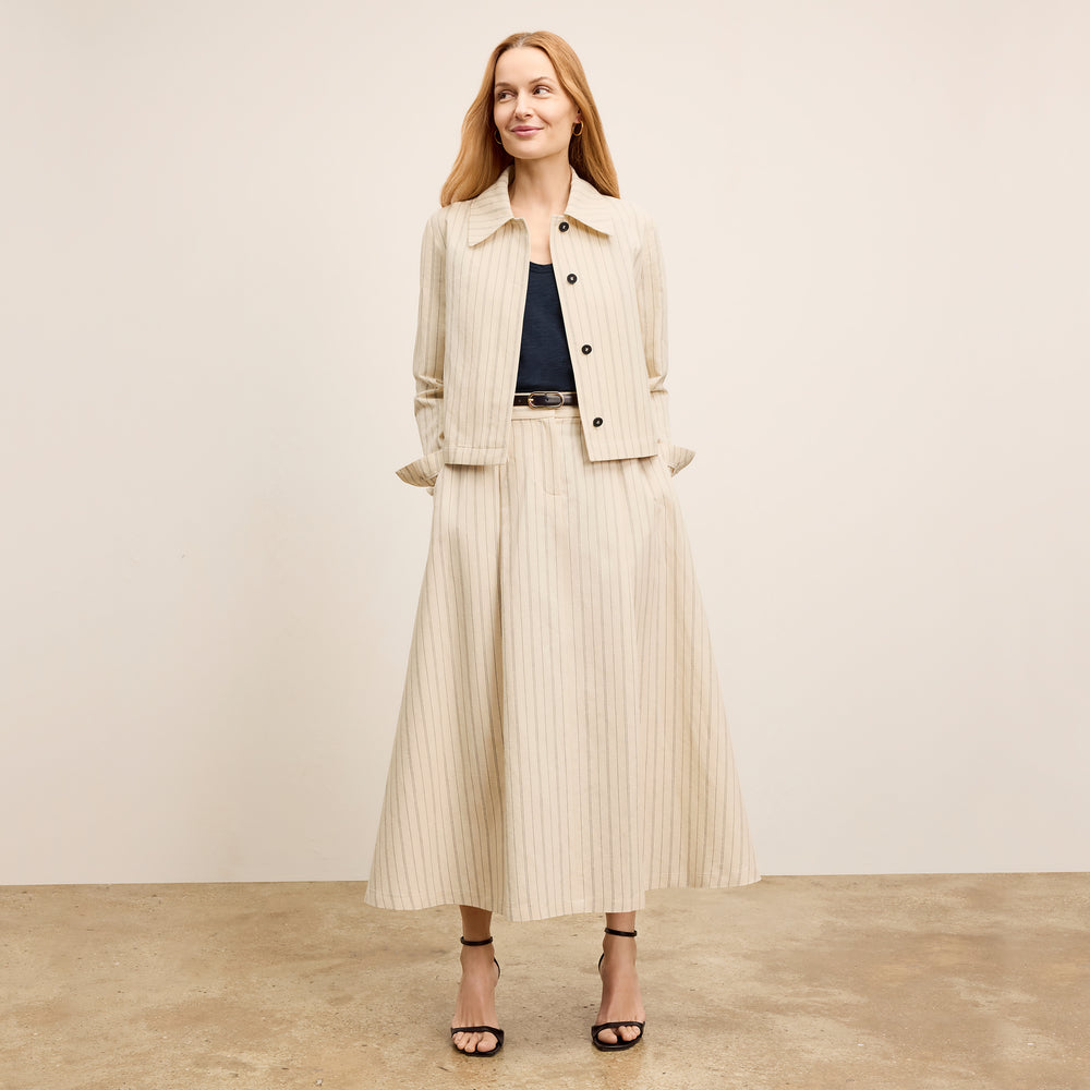 front image of a woman wearing the olia skirt in linen stripe