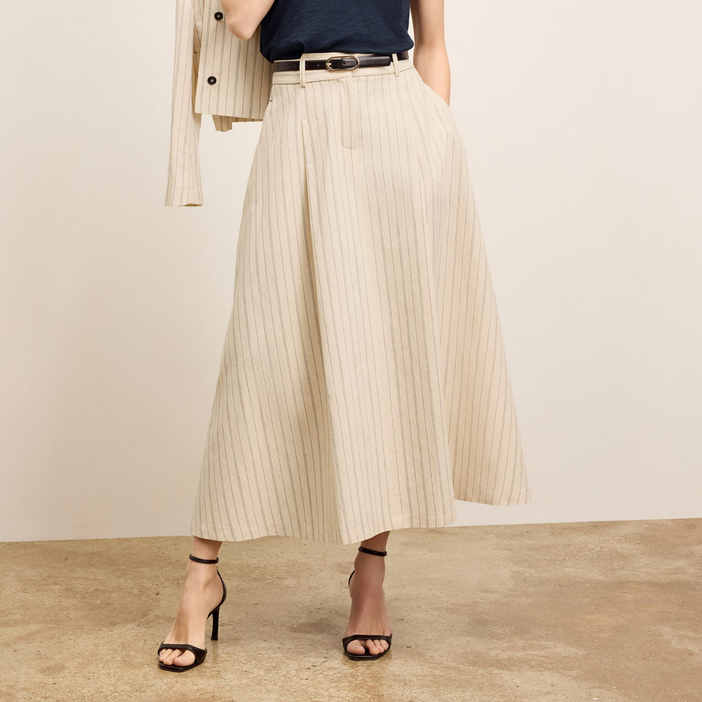 front image of a woman wearing the olia skirt in linen stripe