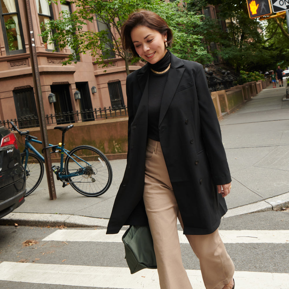 Sarah LaFleur wearing the Gwynne Dress in black as a jacket