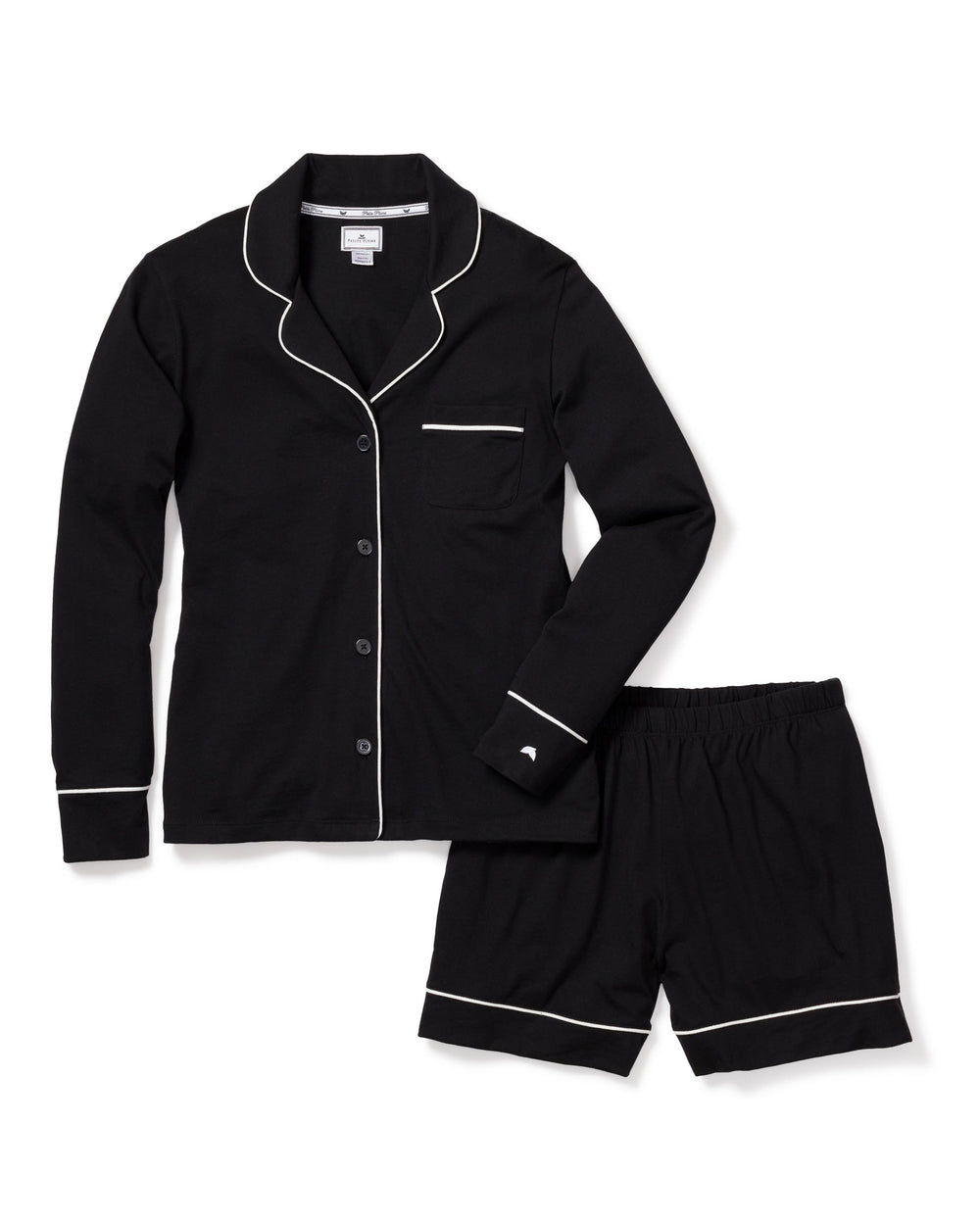 Black pajama set with white piping on a white background