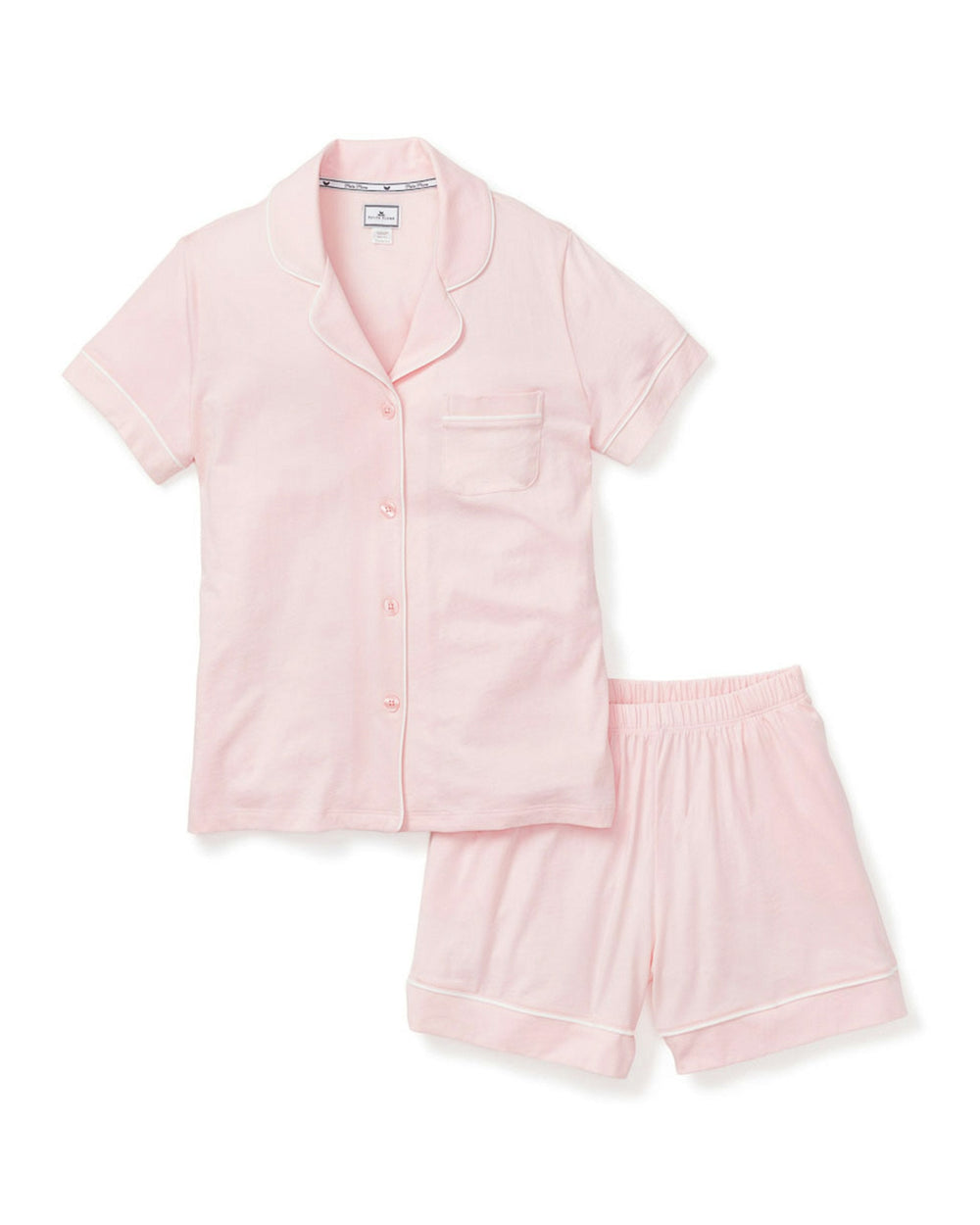 Pink pajama set with shirt and shorts on a white background