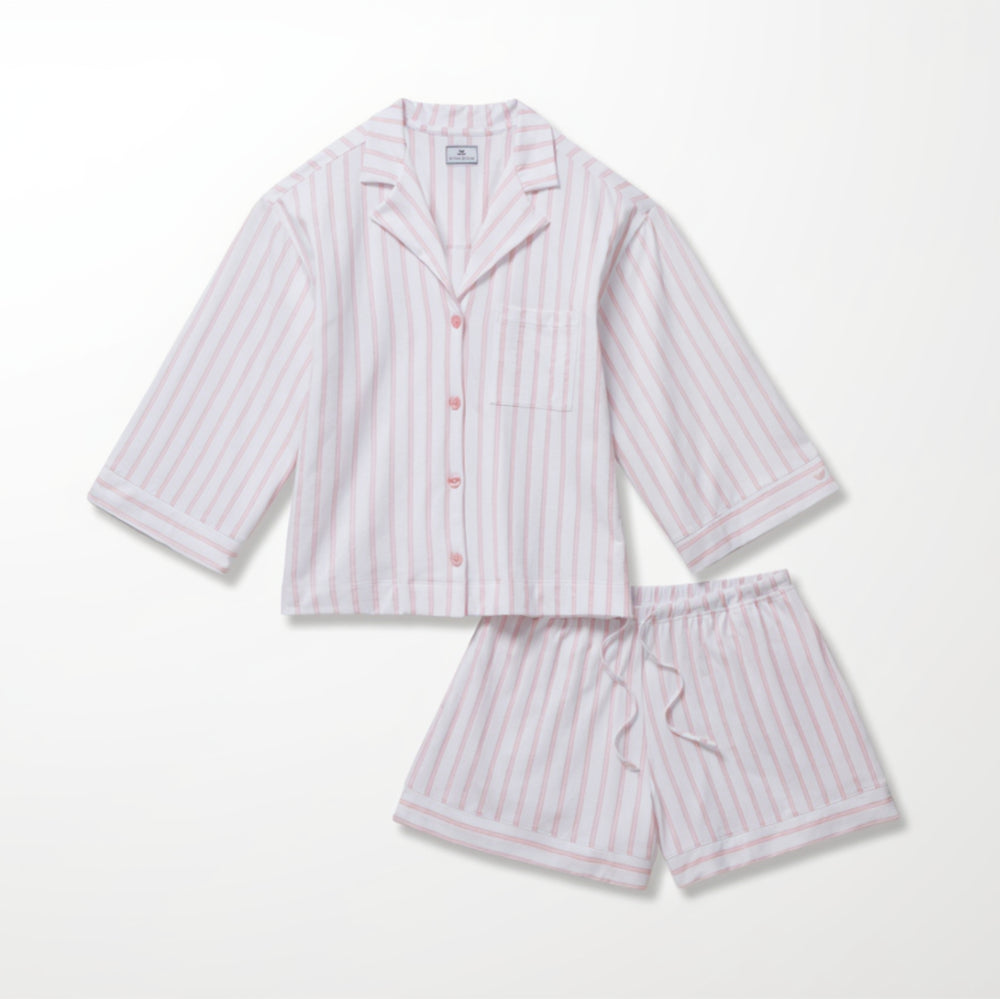 Pink and white striped pajama set on a white background