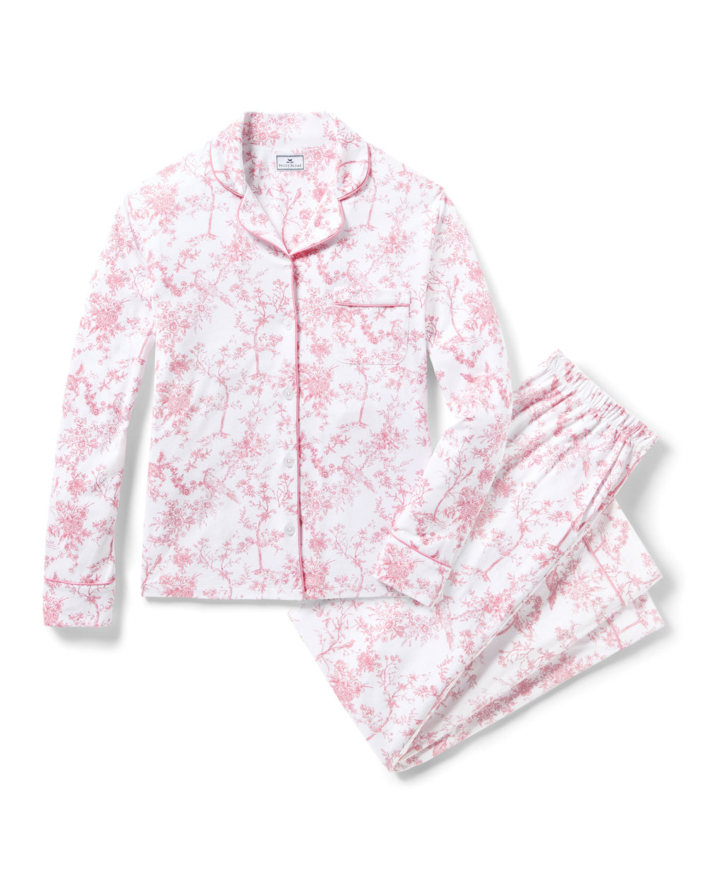 Pink and white floral pajama set on a white background