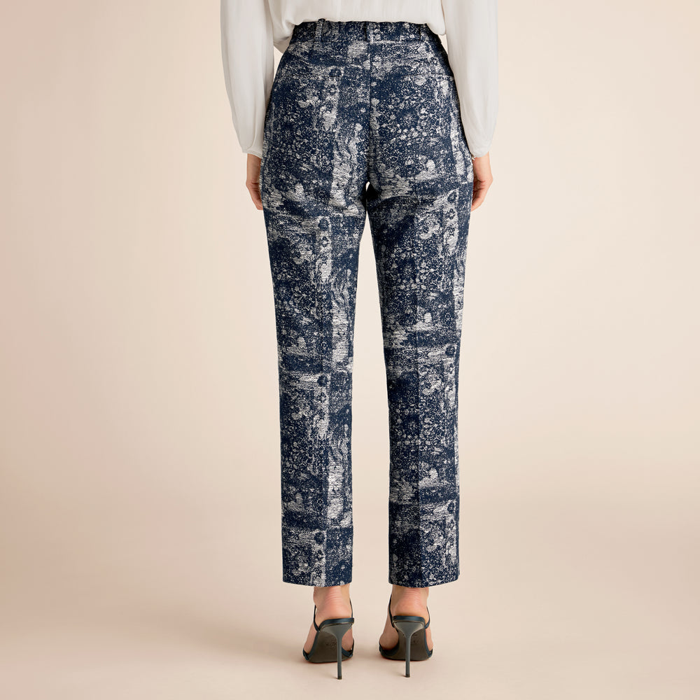 Patterned pants worn by a person on a beige background