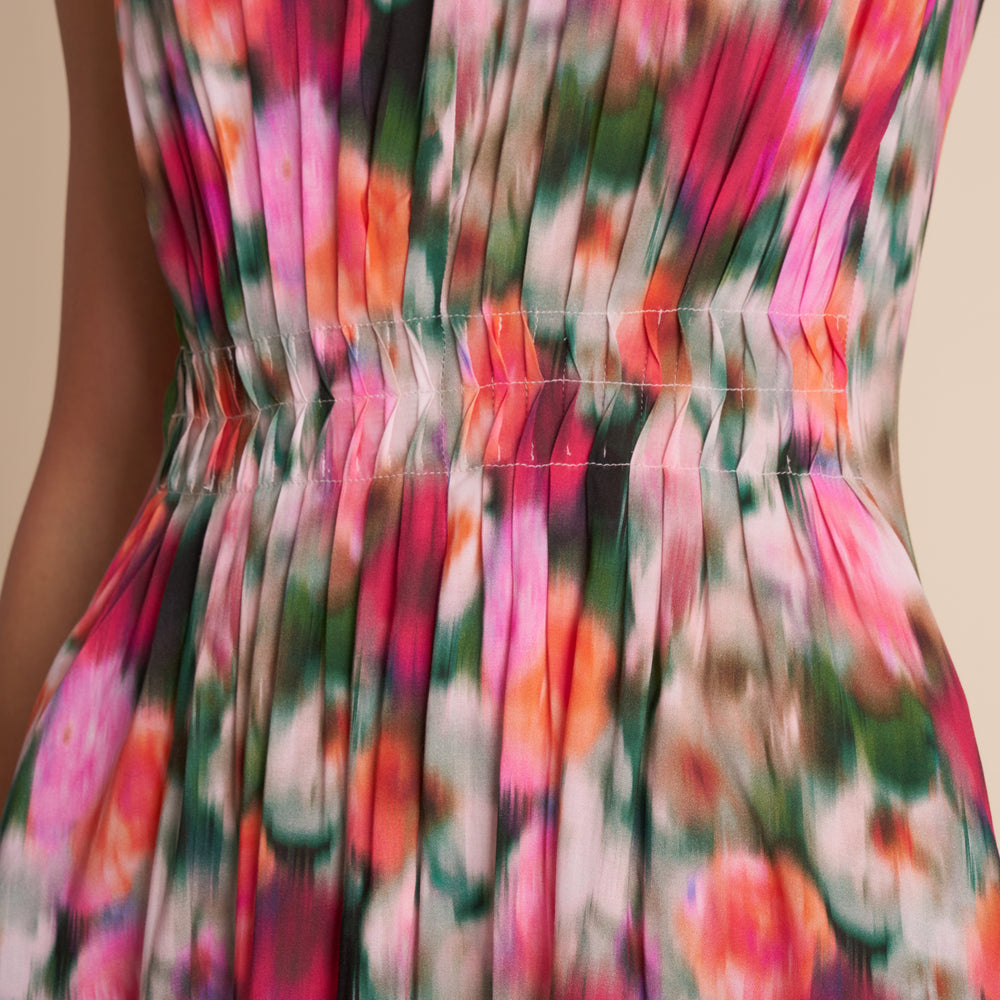 Close-up of a colorful floral dress with a beige background