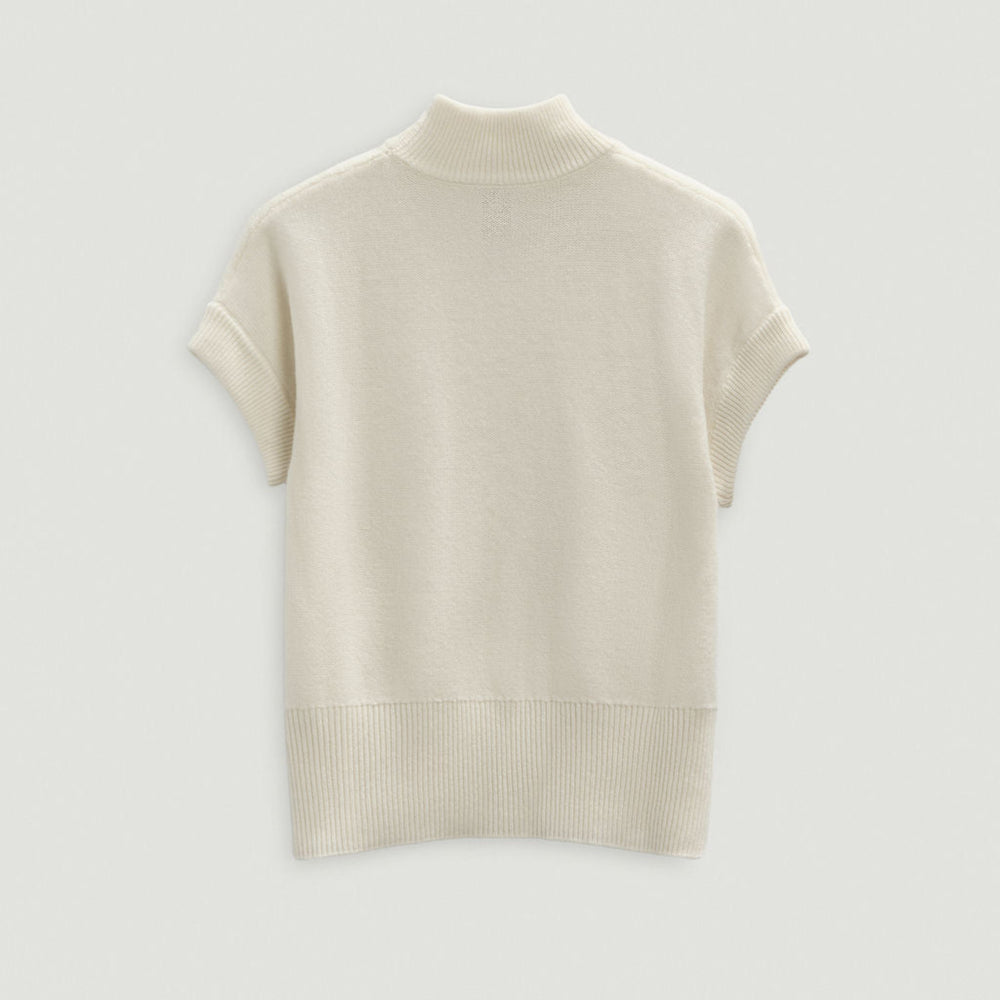 Beige turtleneck sweater on a light gray background
