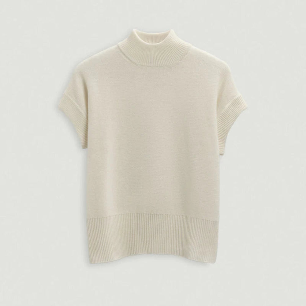 Beige turtleneck sweater on a light gray background