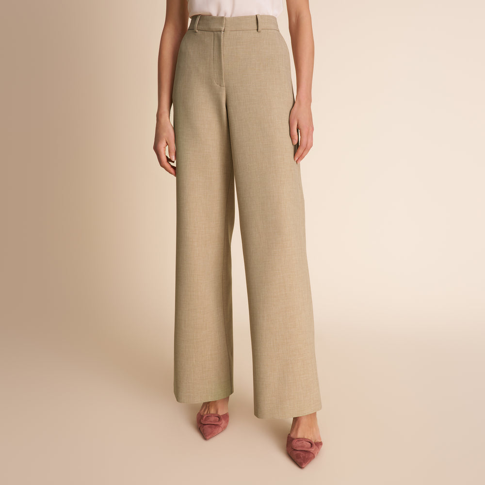 Beige wide-leg pants worn by a person on a beige background