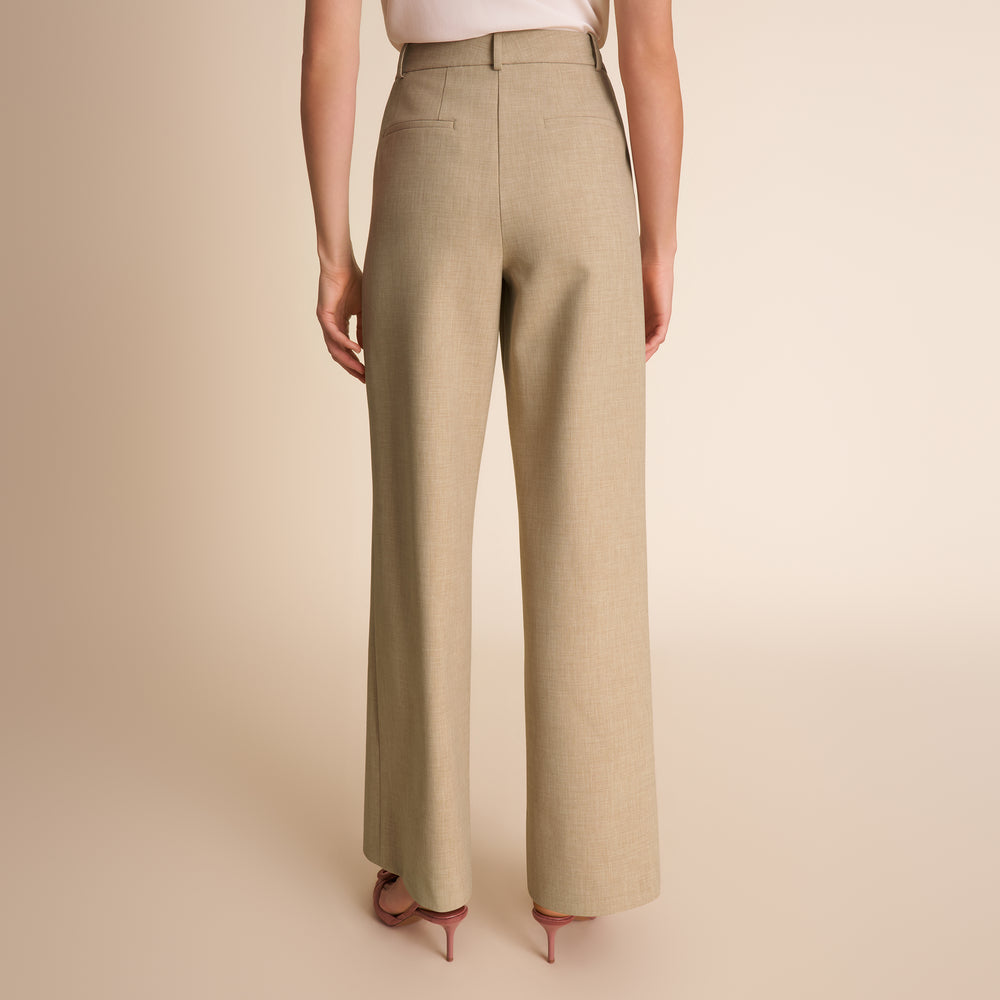 Beige pants worn by a person on a beige background