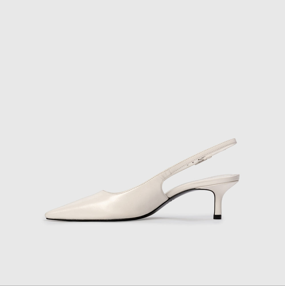White slingback shoe on a light gray background