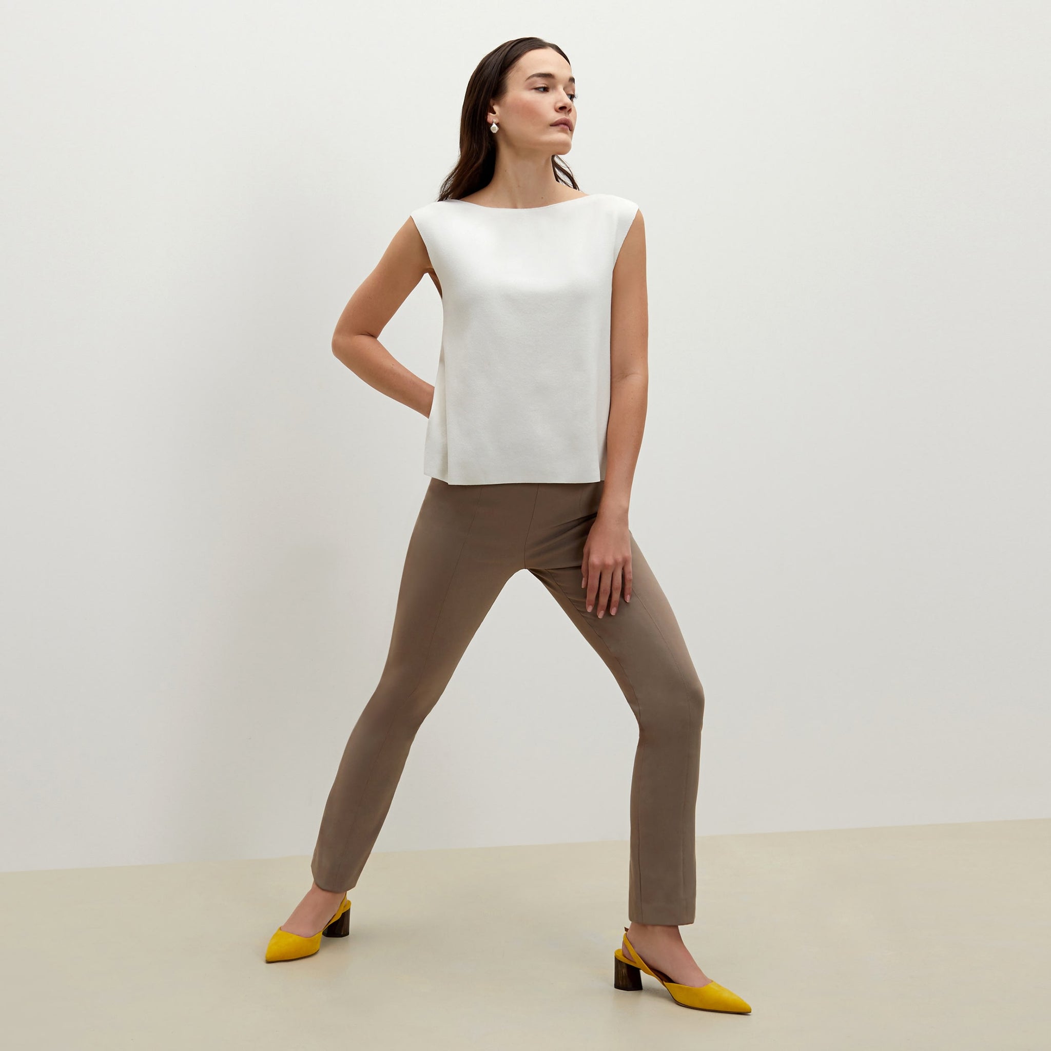 Side image of a woman standing wearing the foster pant in russet