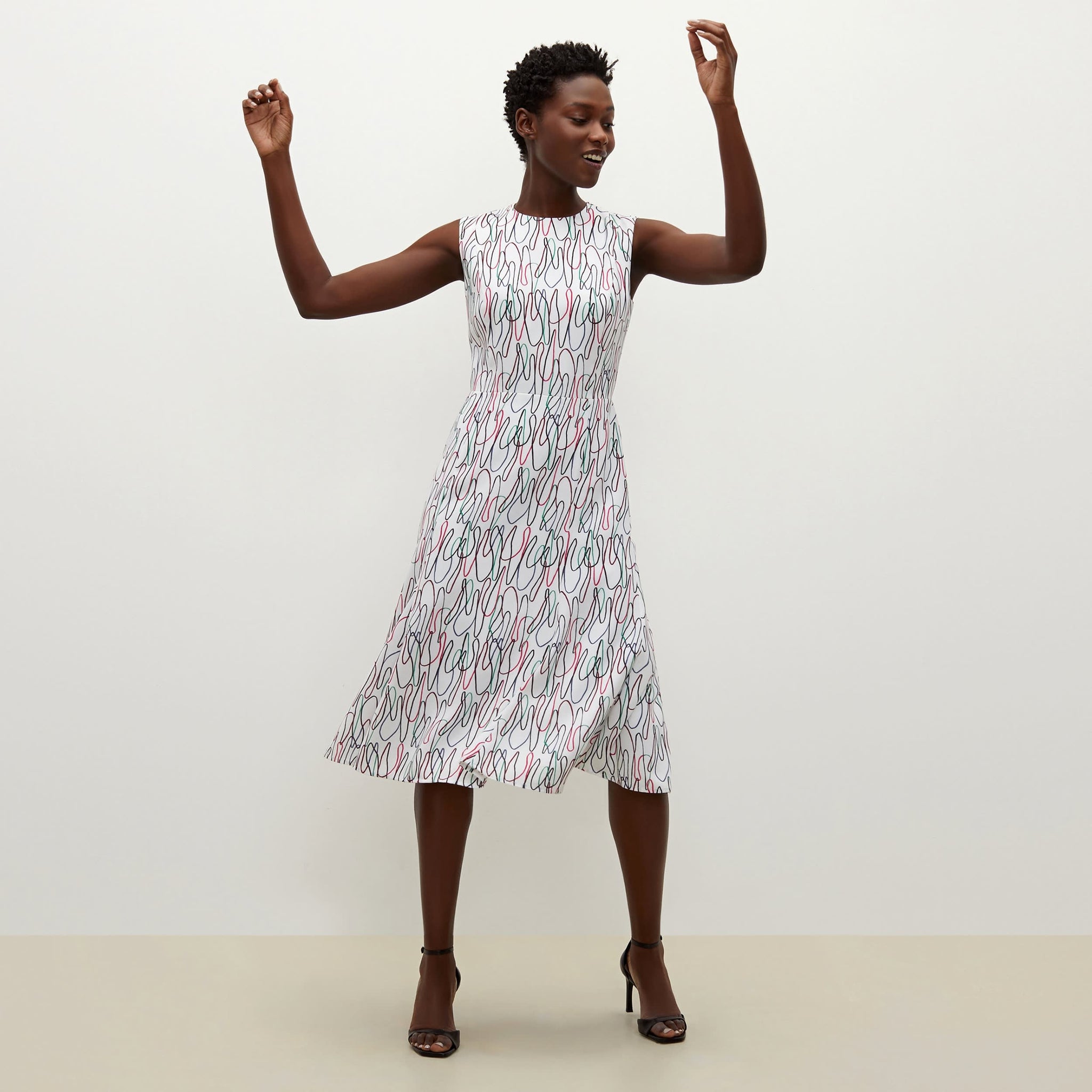 Front image of a woman standing wearing the Jane dress in multicolor 