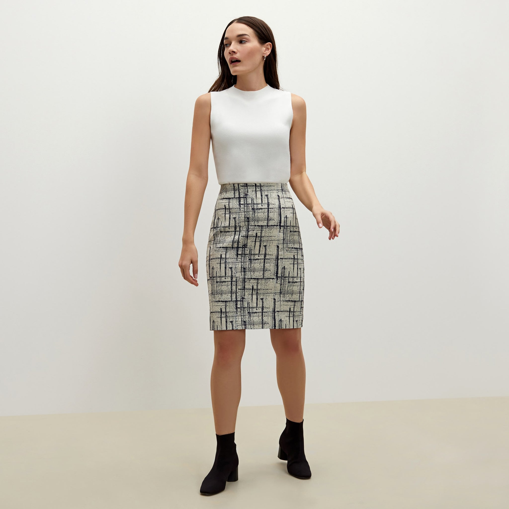 Front image of a woman standing wearing the Noho skirt in ivory / galaxy blue 
