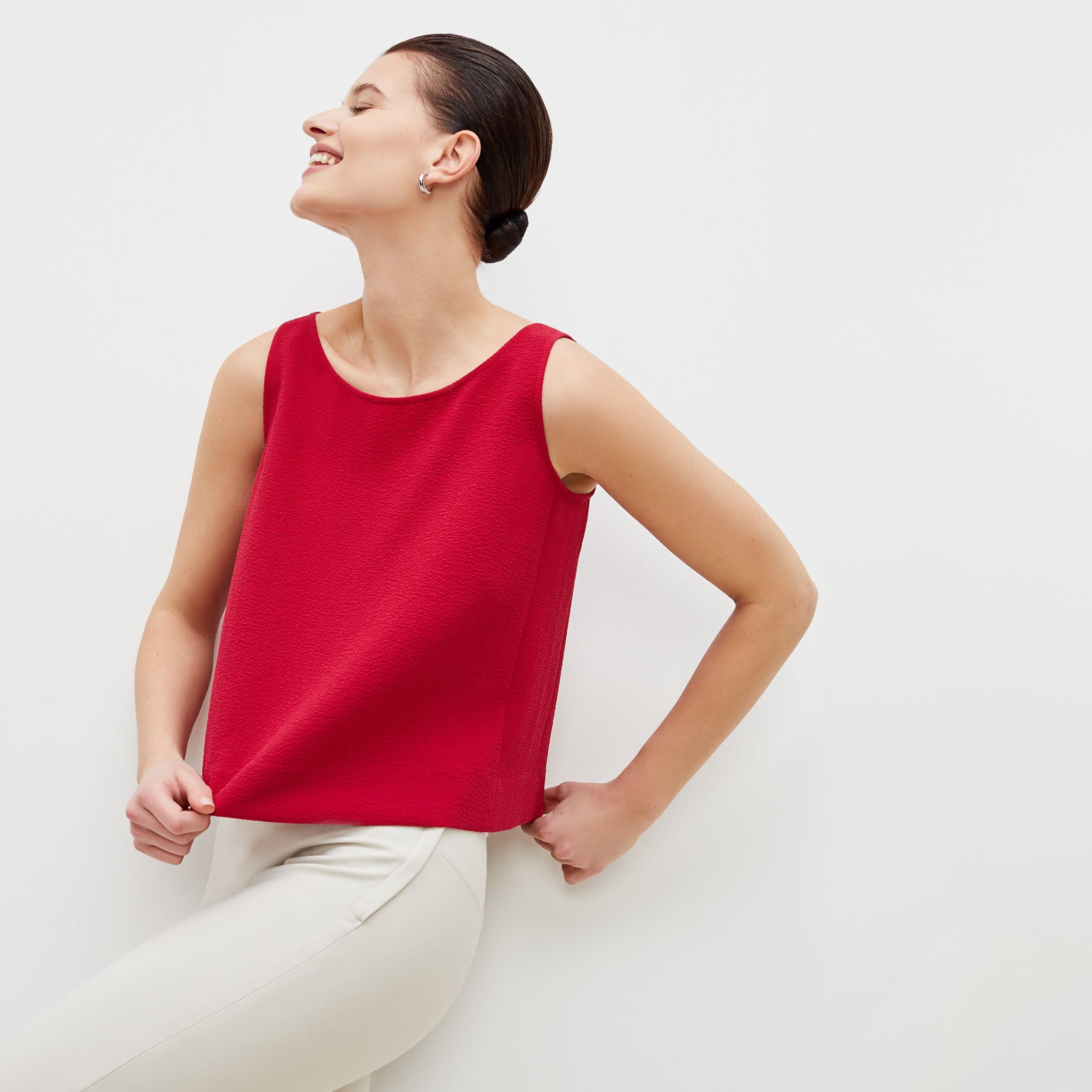 Front image of a woman standing wearing the flaka top in staccato in hibiscus 
