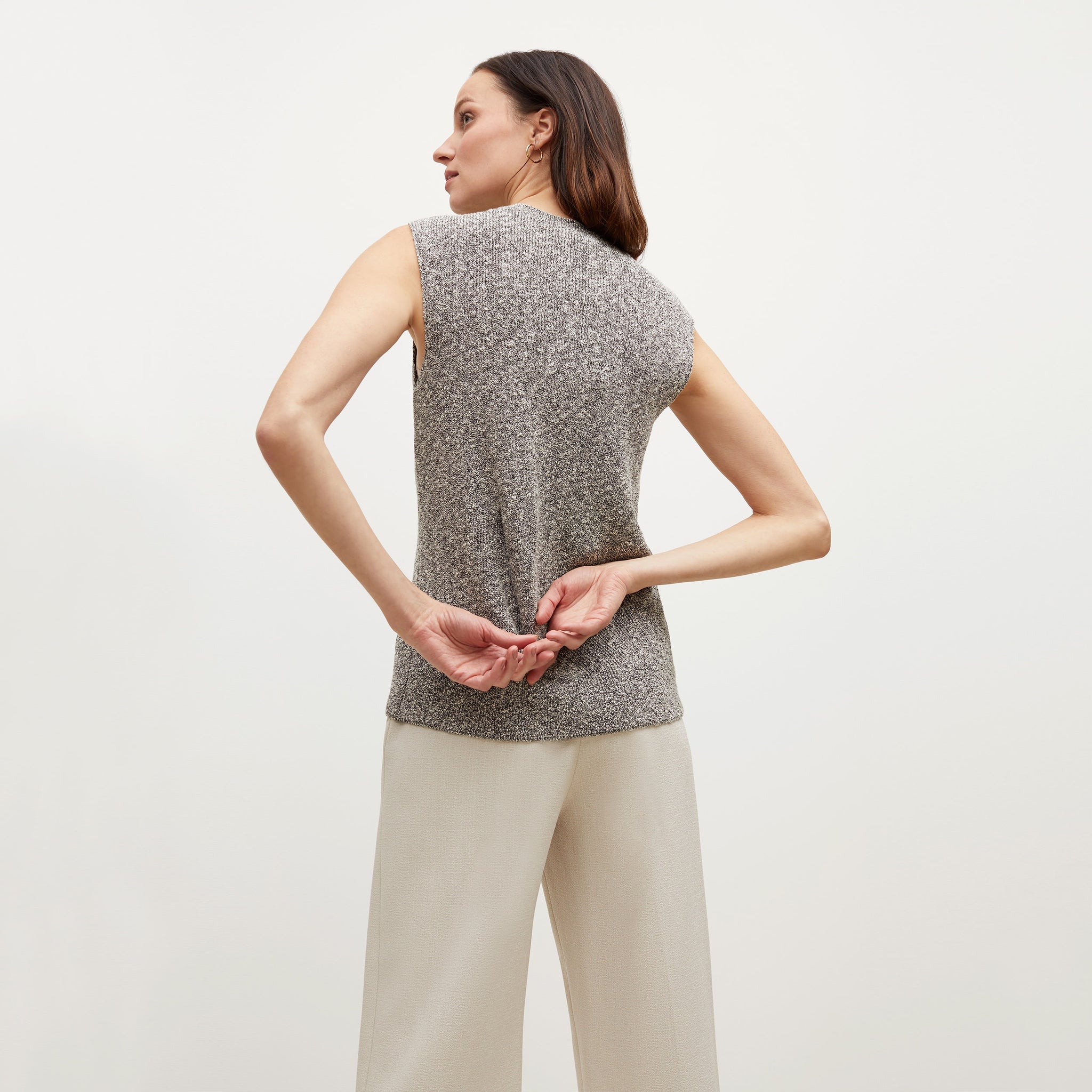 Back image of a woman standing wearing the Barbara Sweater—Knit Boucle in Black / White