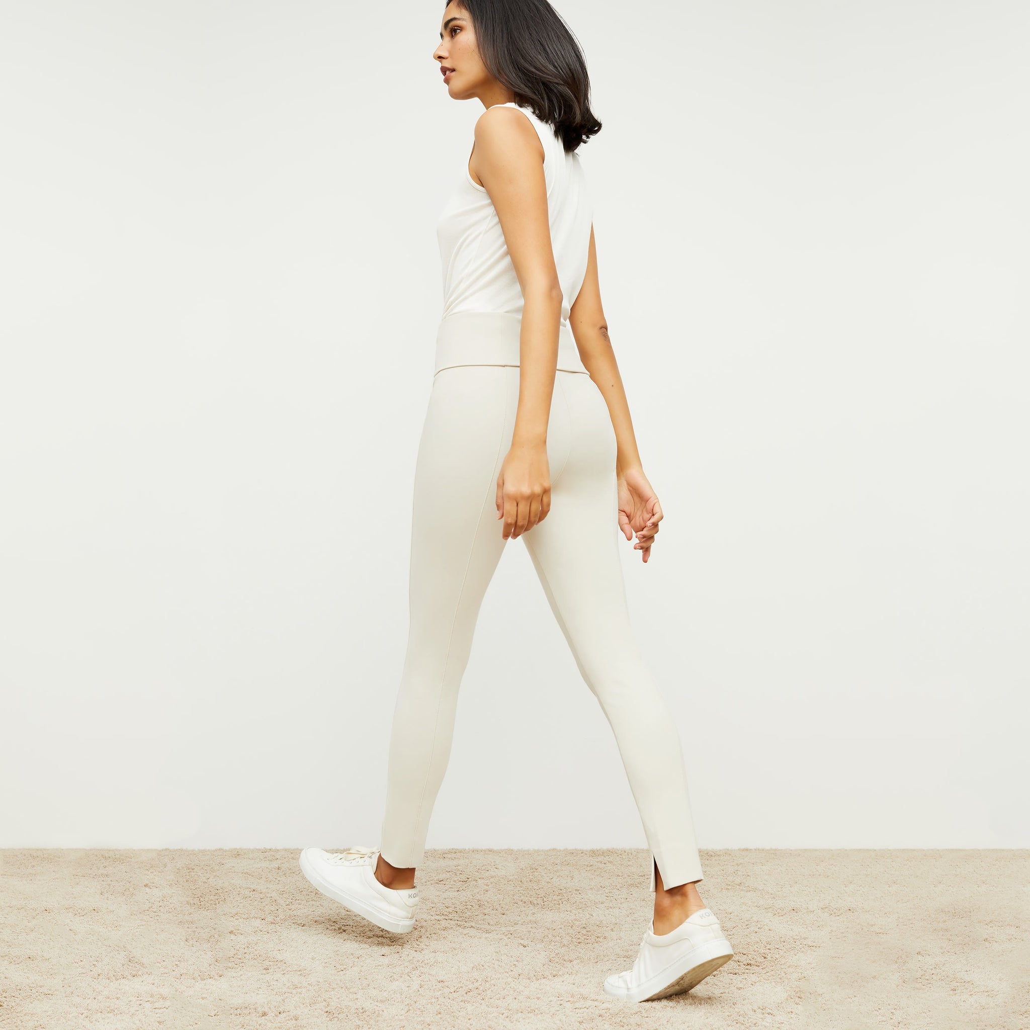 Back image of a woman standing wearing the stella legging in pearl