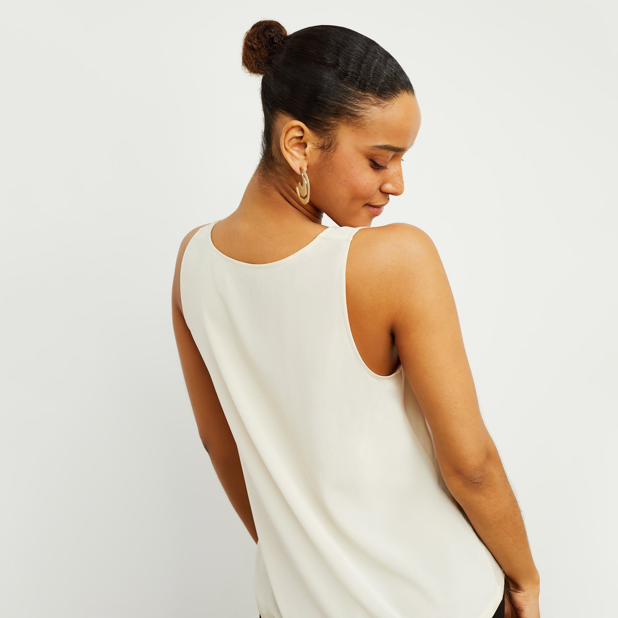 Back image of a woman standing wearing the Vicky Tank—Washable Silk in Pearl
