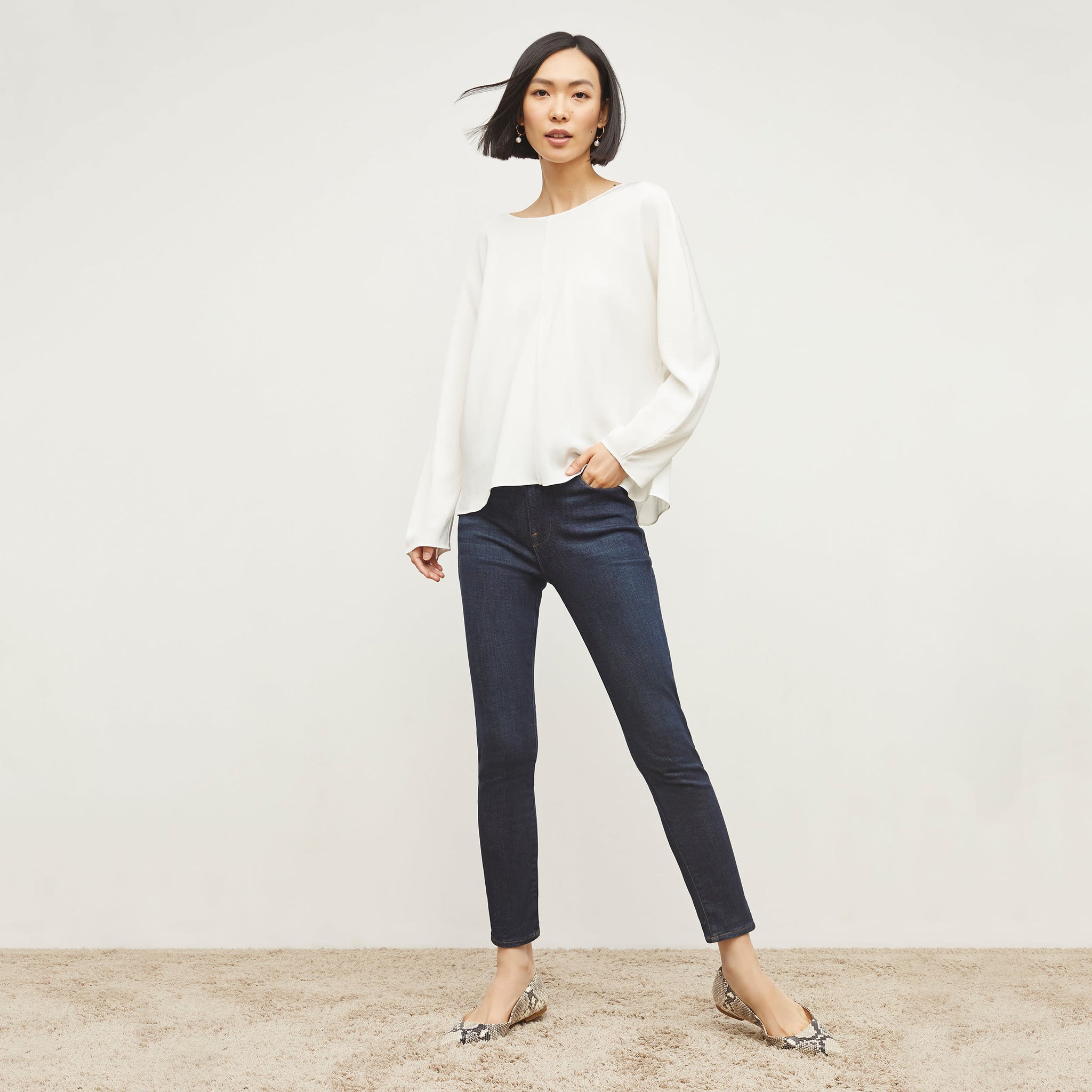 Front image of a woman standing wearing the FRAME Denim Le High Skinny Crop Jean in Samira 