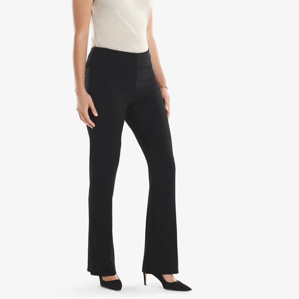 Side image of a woman standing wearing the Clooney pant in light twill in black.