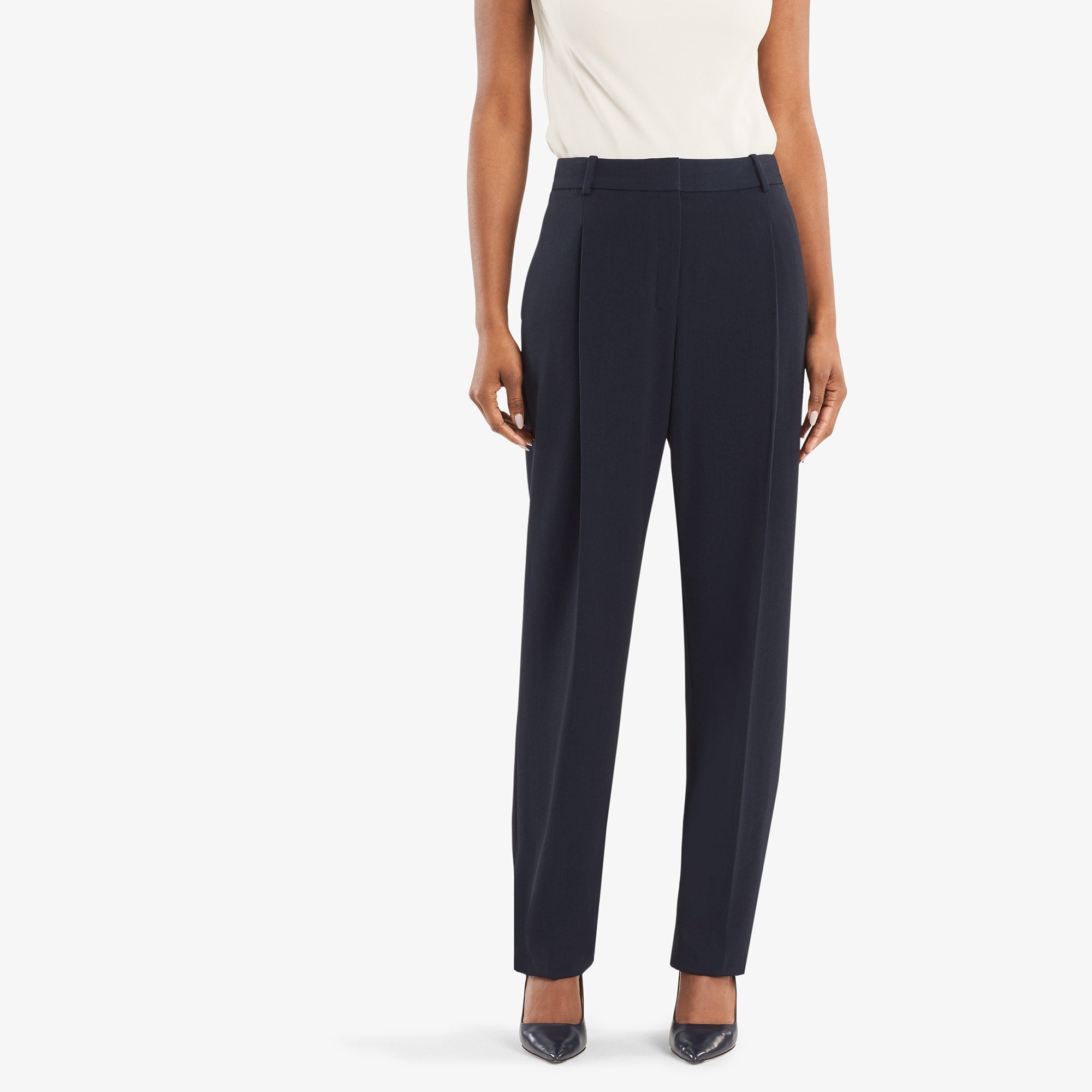 Front image of woman standing wearing the Elliott trouser in navy. 