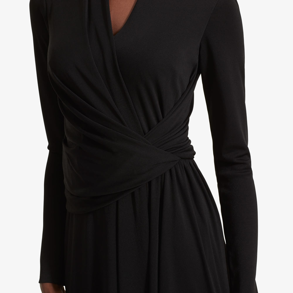 Detail image of a woman standing wearing the Morgan dress in Black