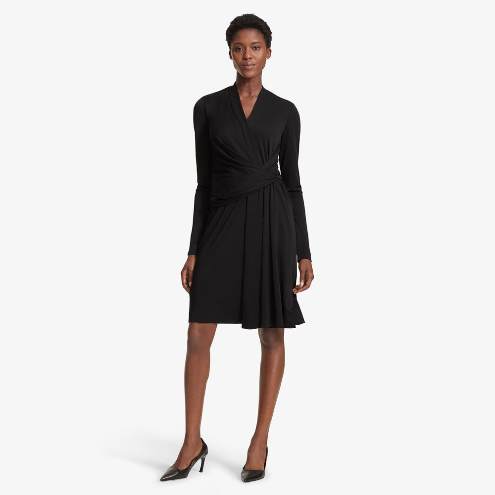Front image of a woman standing wearing the Morgan dress in Black
