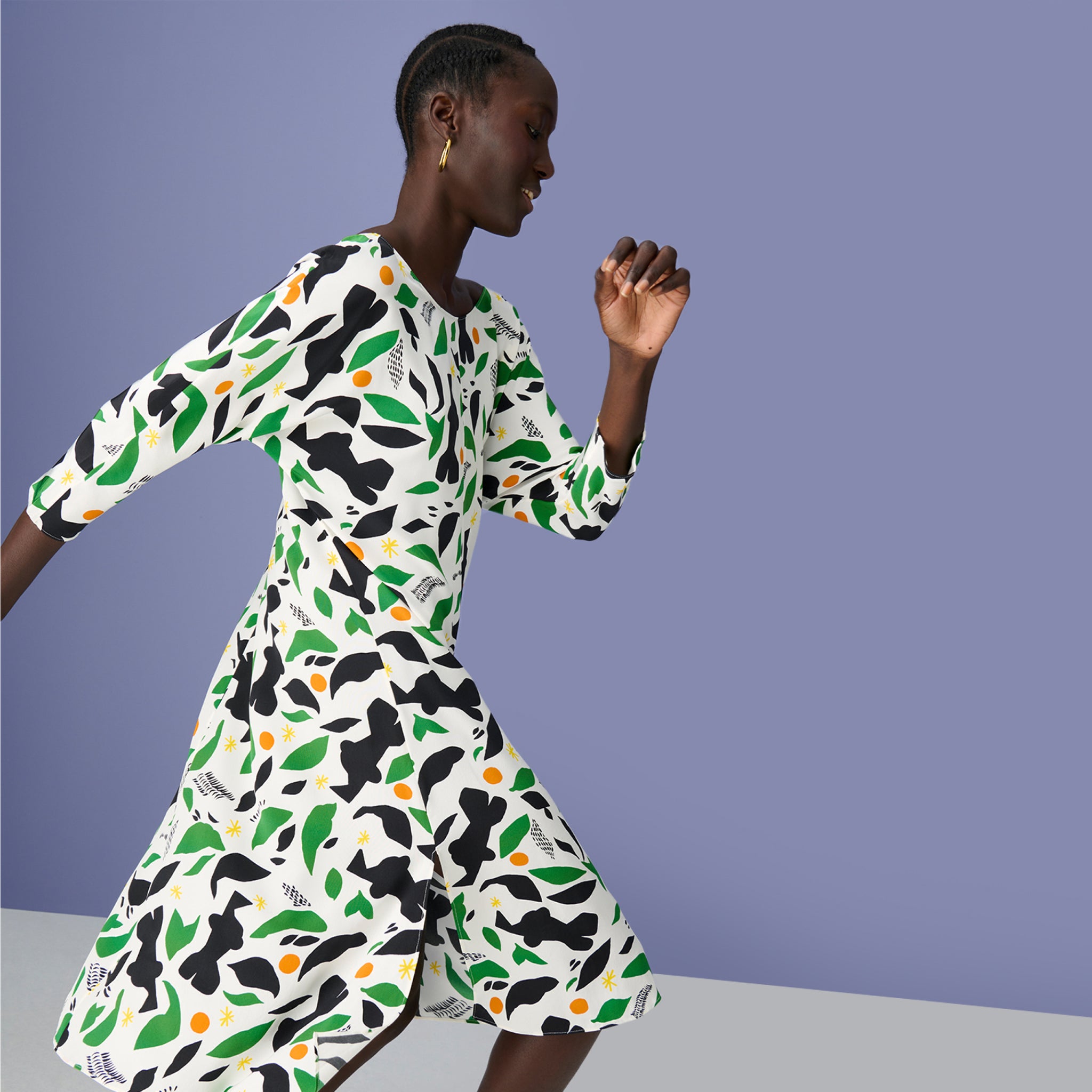 Side image of woman wearing the alesia dress in icon print