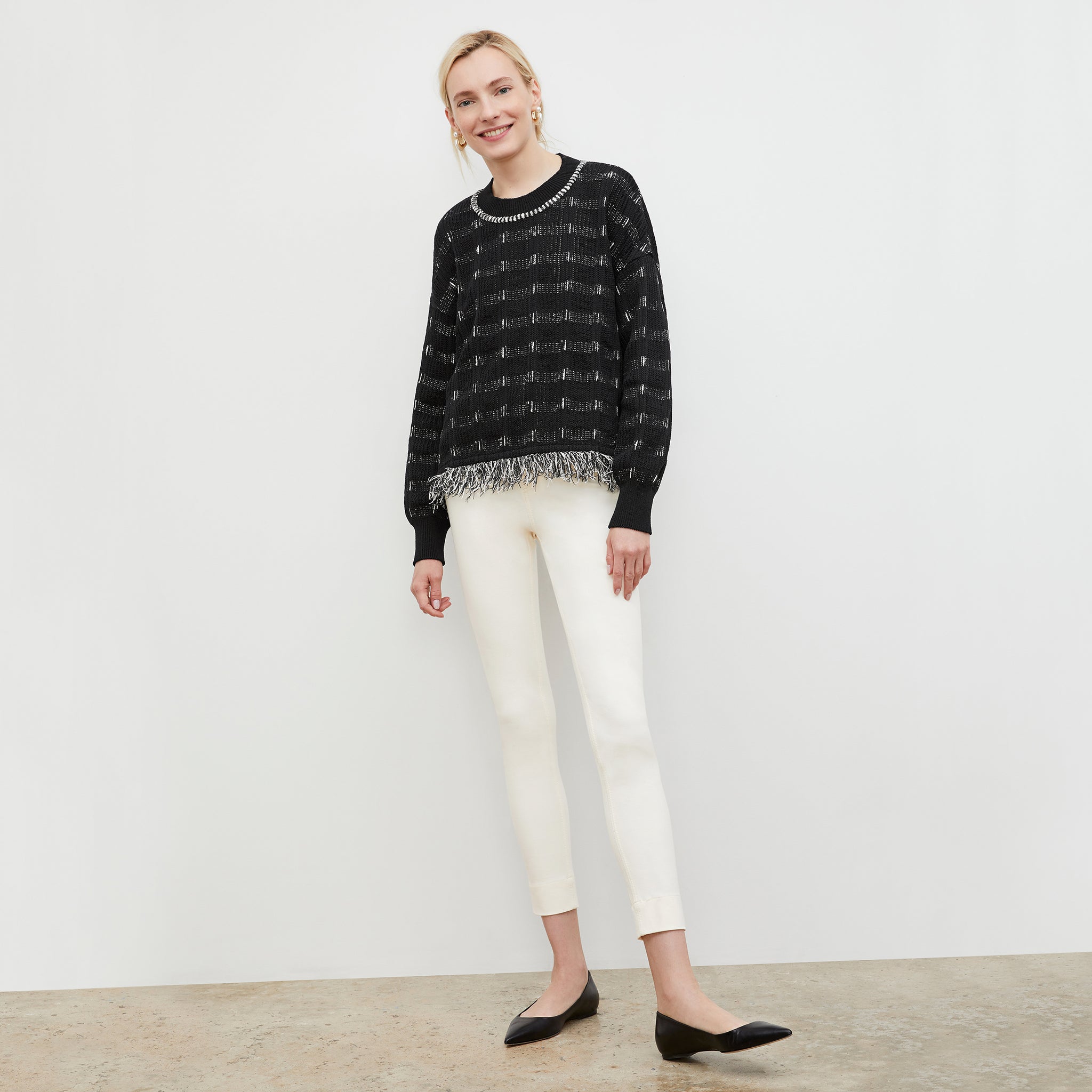 Front image of a woman wearing the Figari Pullover - Linear Interweave in Black / White  