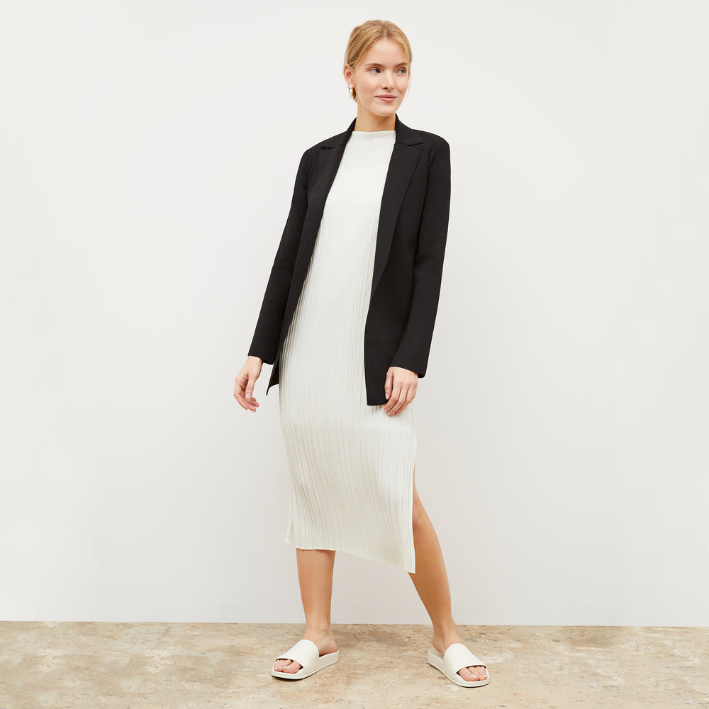 Front image of a woman wearing the Edith Dress - Micro Pleat in Ivory