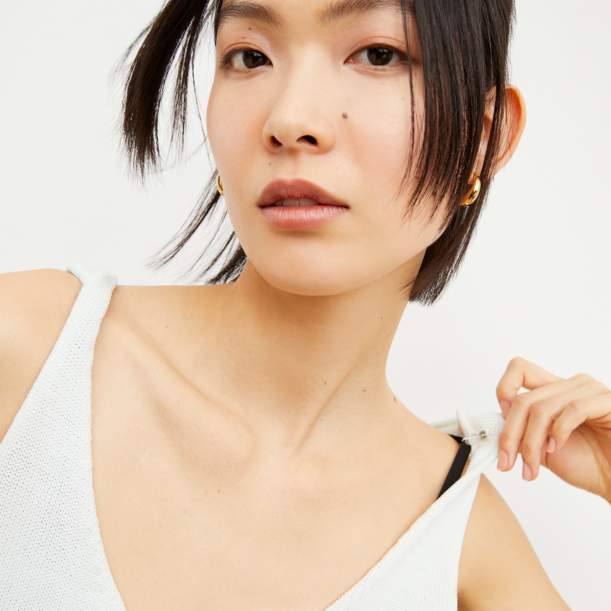 Image of a woman wearing the Melody Tank in Ivory