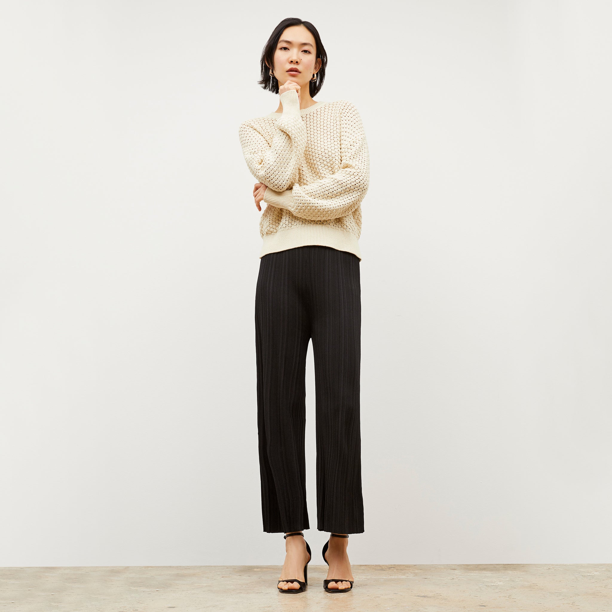 Side image of a woman wearing the Marijane Pant - Textured Knit in Black