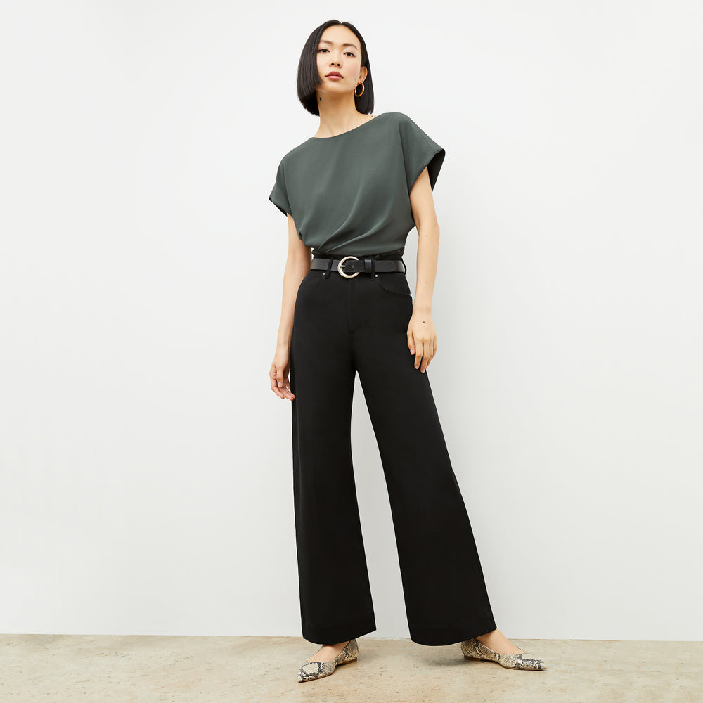 Front image of a woman wearing the Circle Buckle Belt in Black