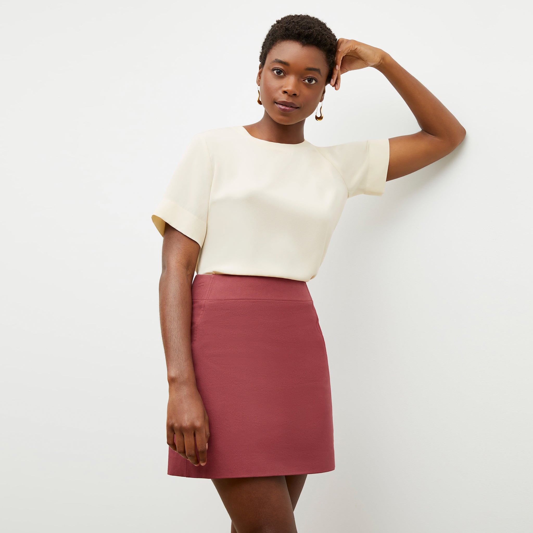 Front image of a woman wearing the rowley skirt in rosewood