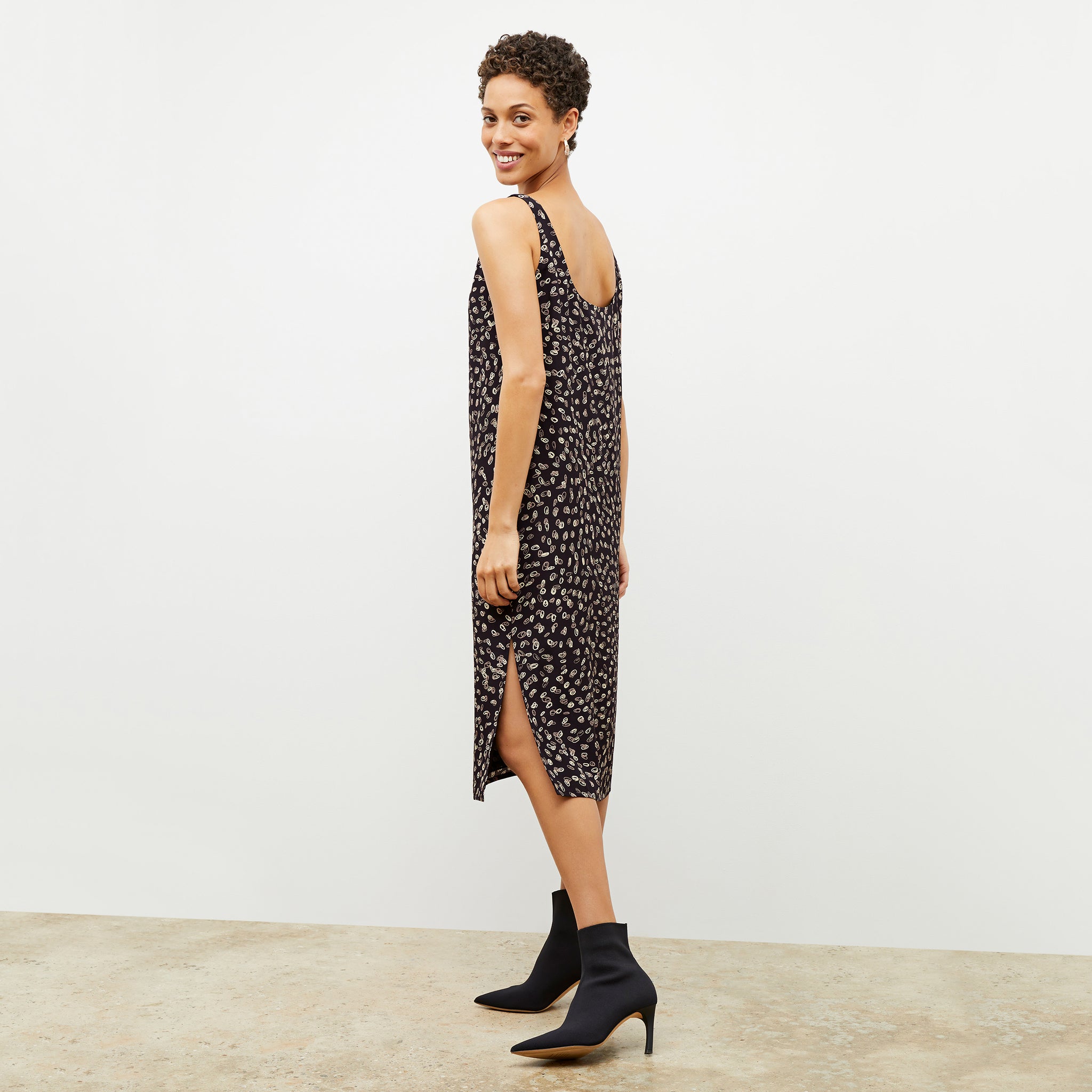 Side image of a woman wearing the Bevin Dress in Spin Dot