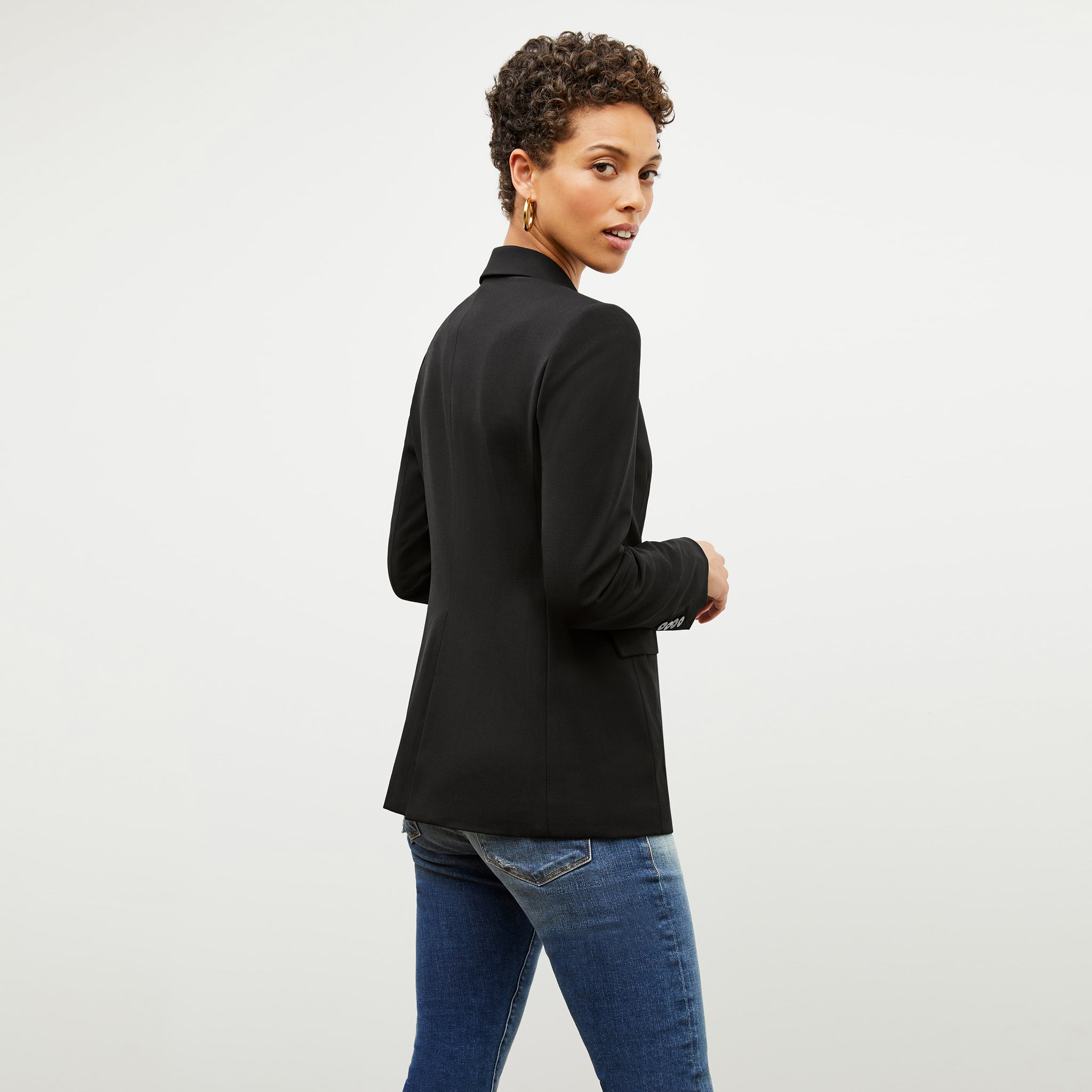 Back image of a woman wearing the kati jacket in black