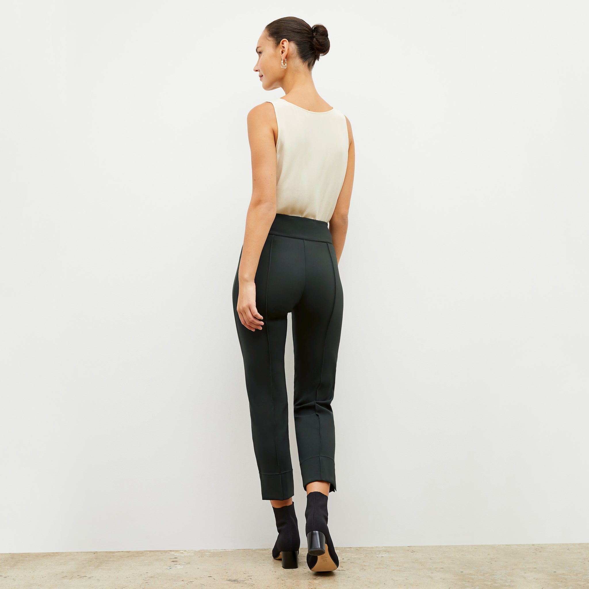 Back image of a woman wearing the robin pant in forest