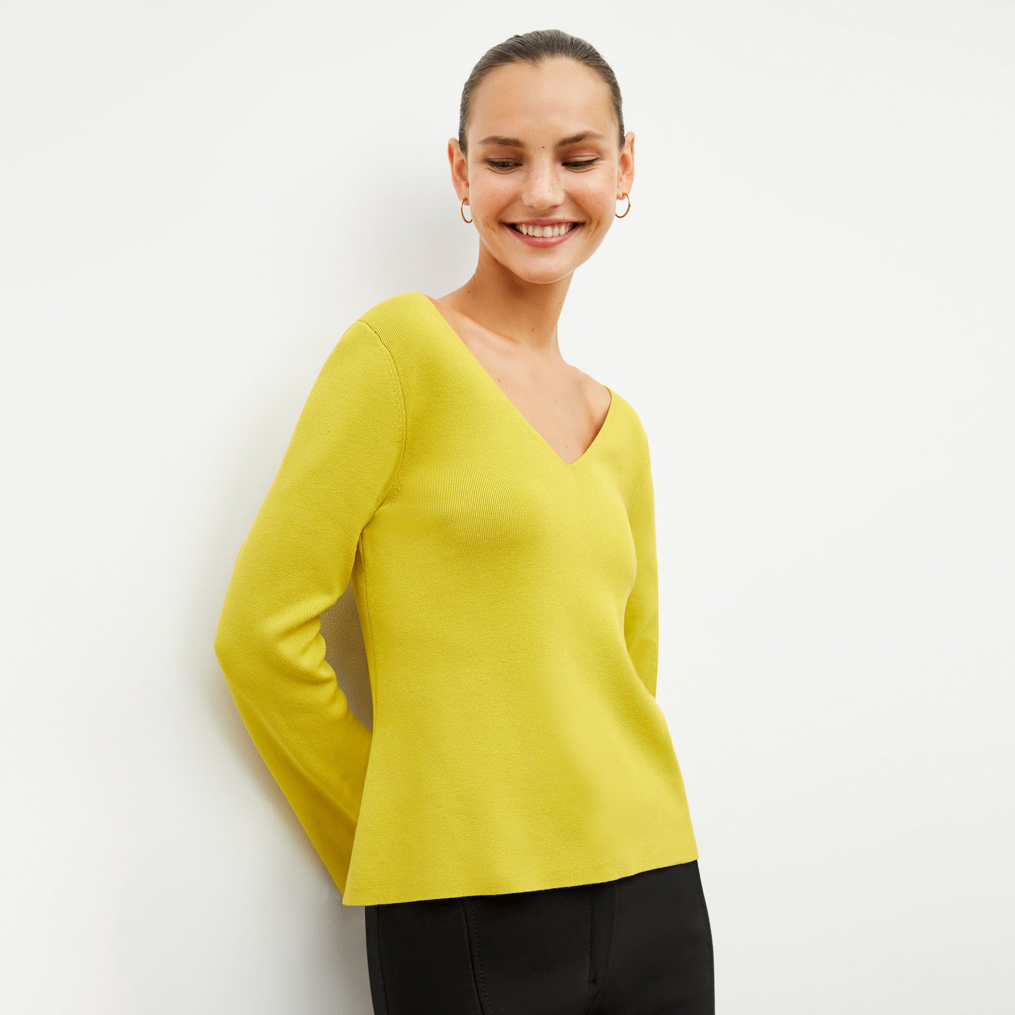 Front image of a woman wearing the kara top in chartreuse 
