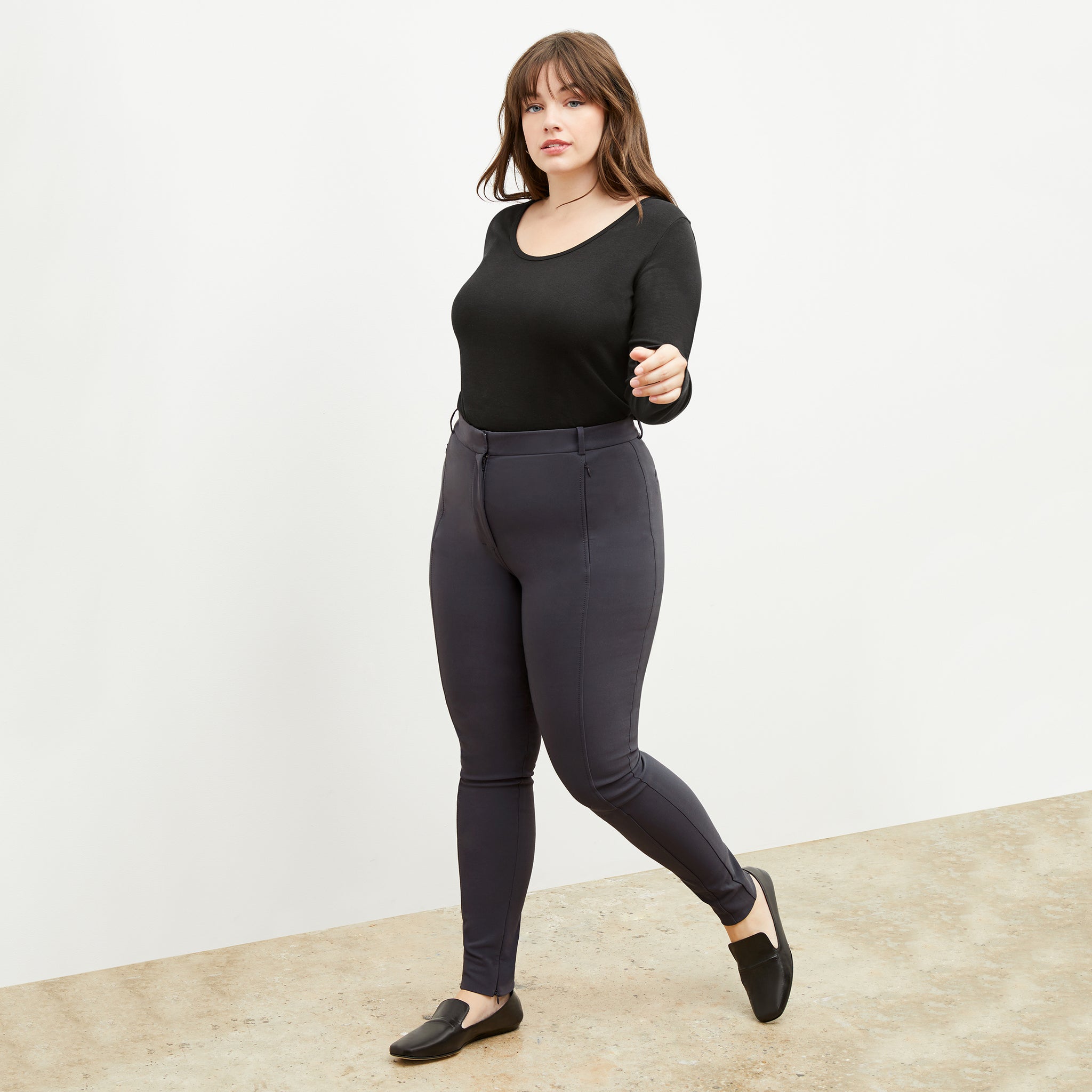 Front image of a woman standing wearing the marcia top in fine ribbed cotton in black