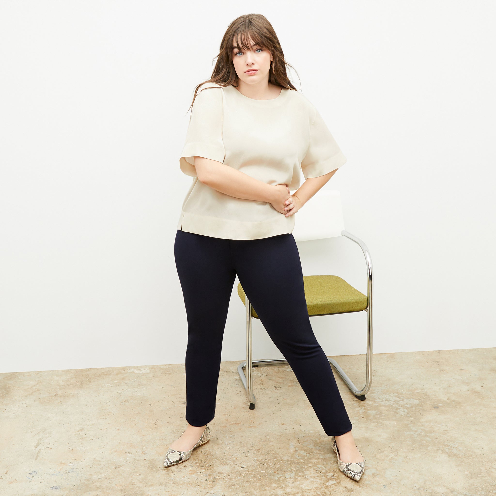 Front image of a woman standing wearing the Annika Tee—Washable Silk in Pearl