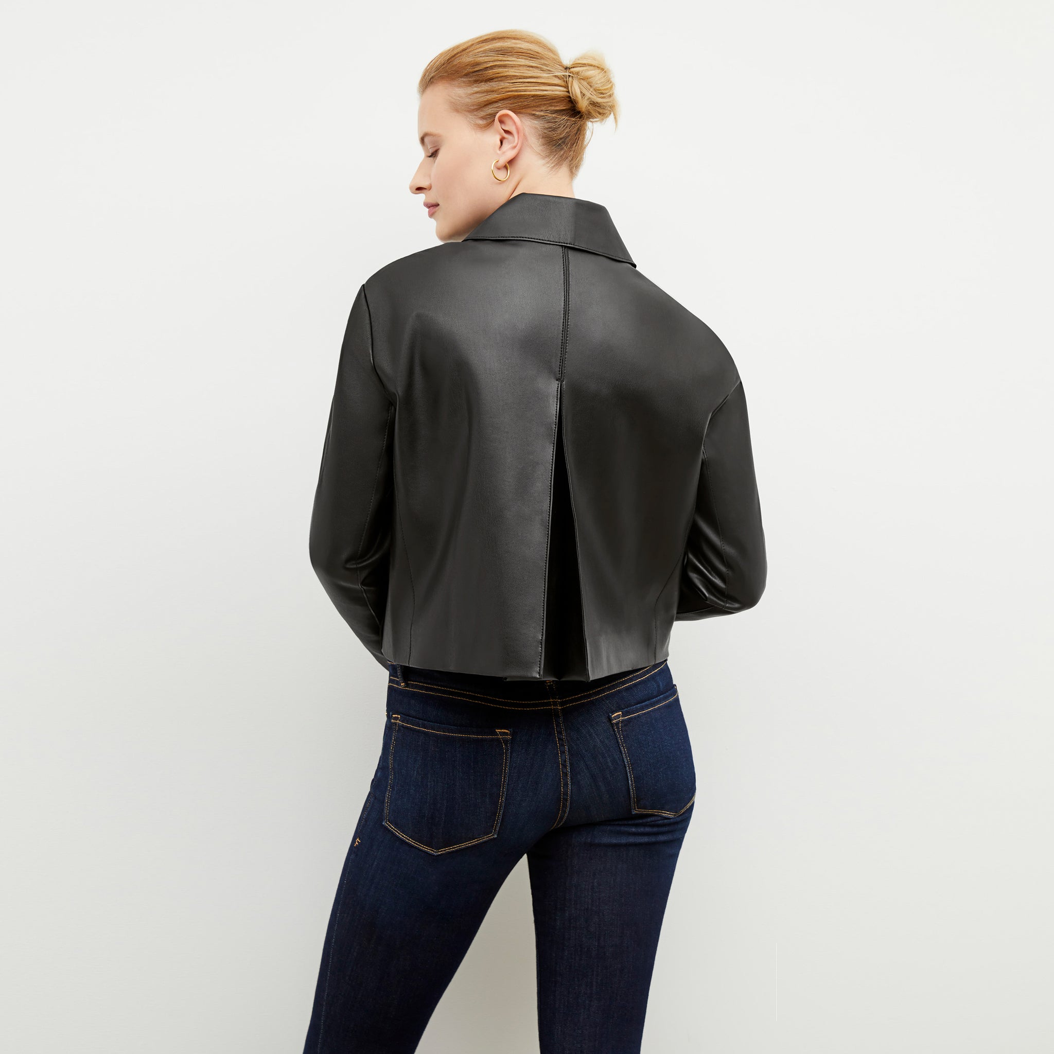 Back image of a woman wearing the nicky jacket in black