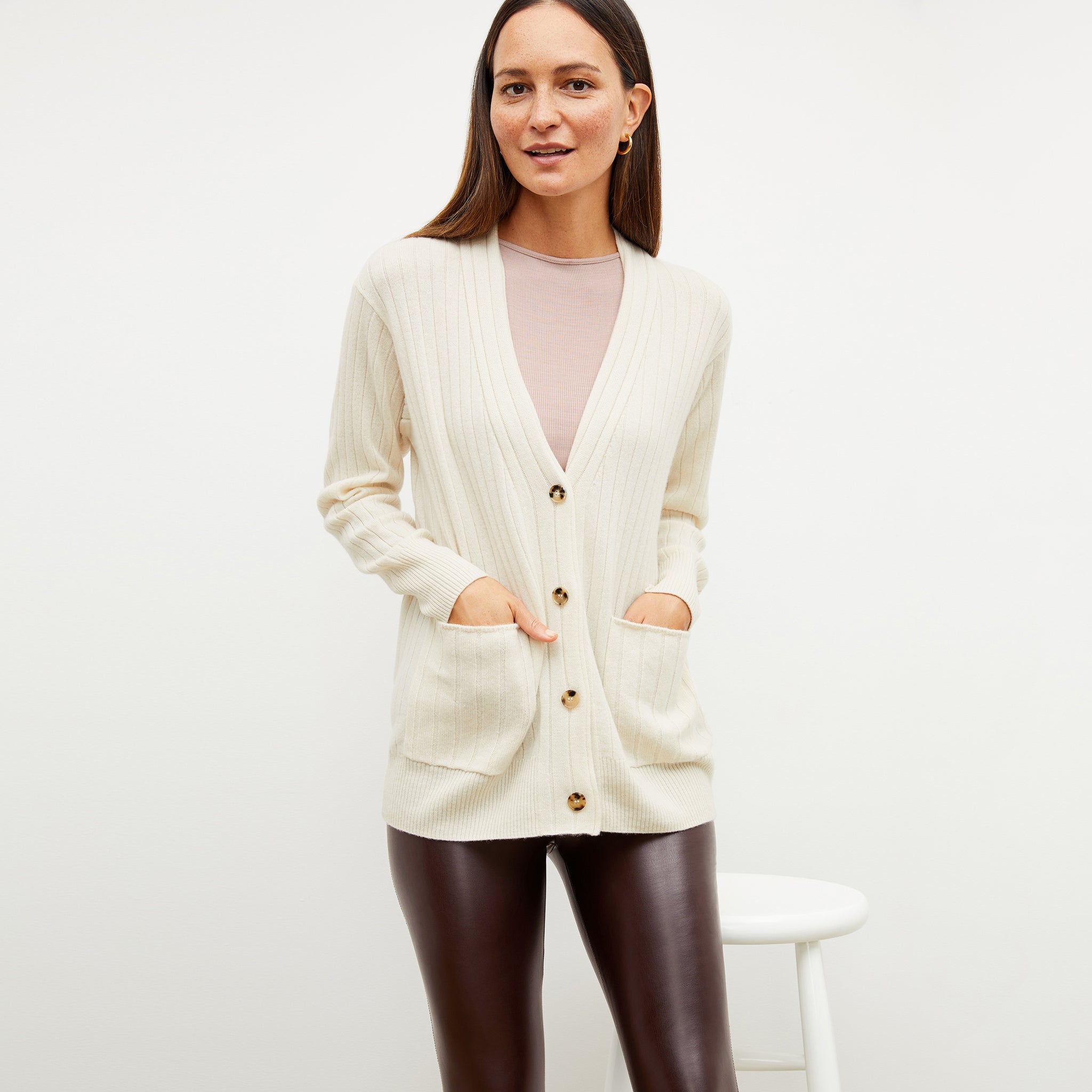 Front image of a woman wearing the caro sweater in light cream