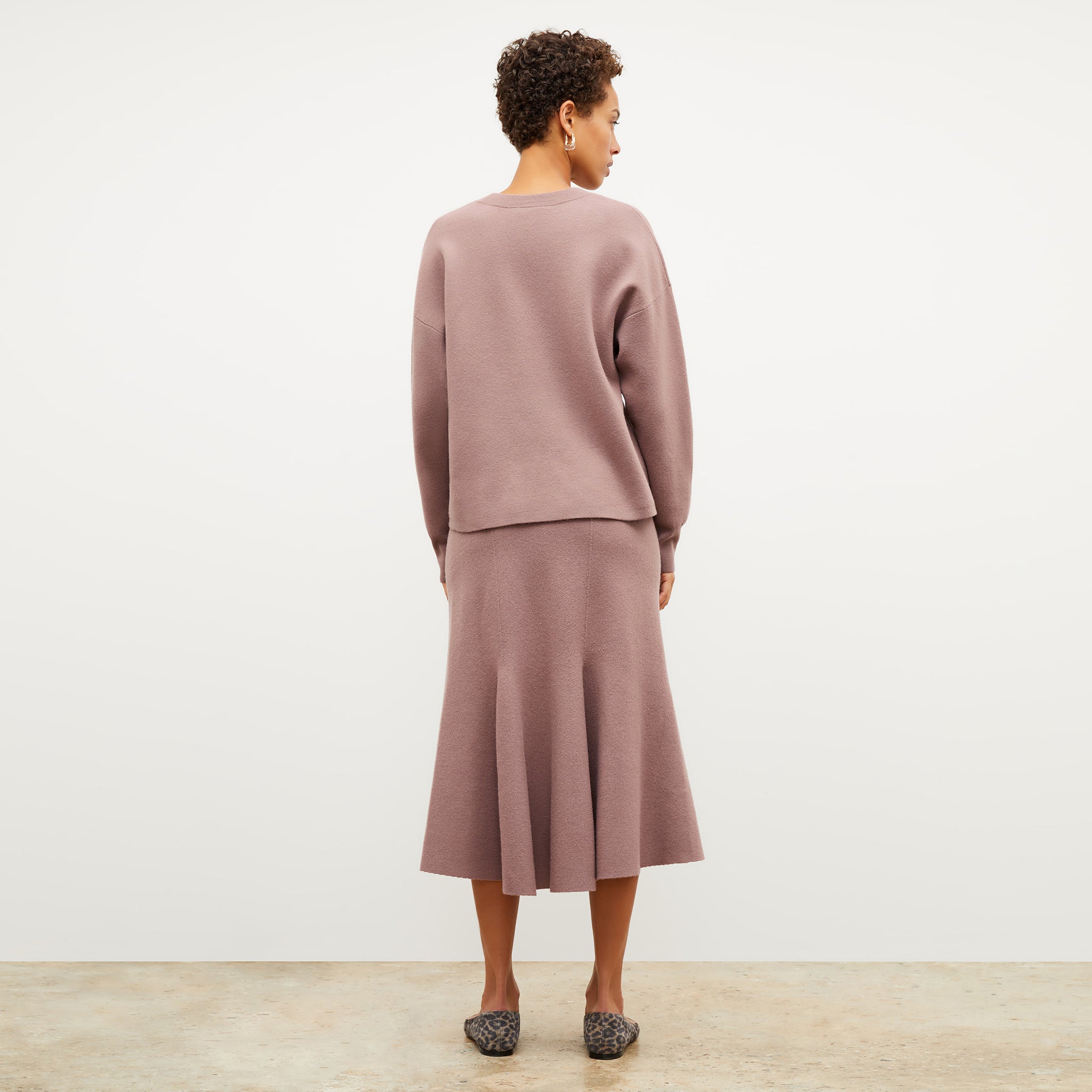 Back image of a woman wearing the quincy sweater in rose taupe