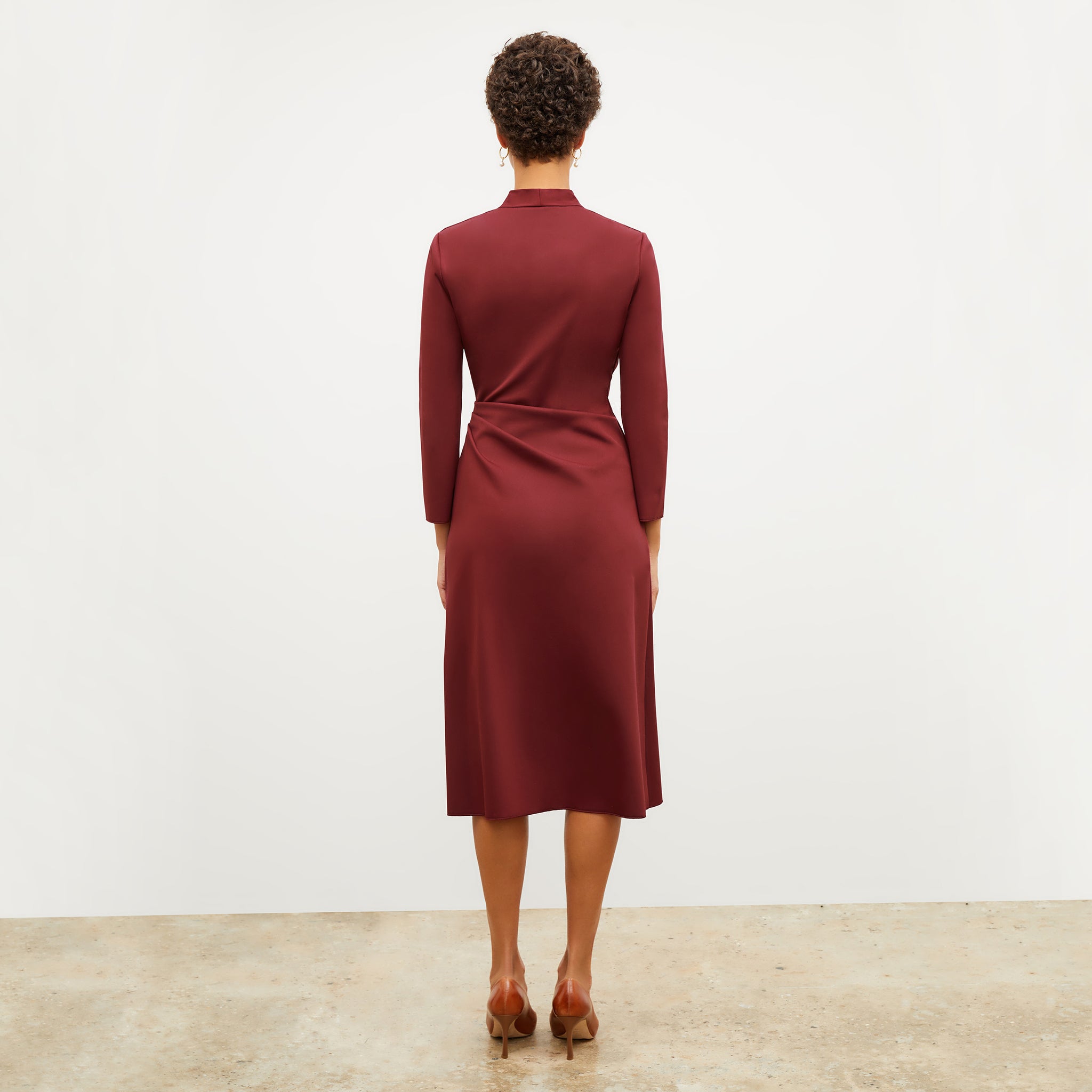 Back image of a woman wearing the carly dress in maroon