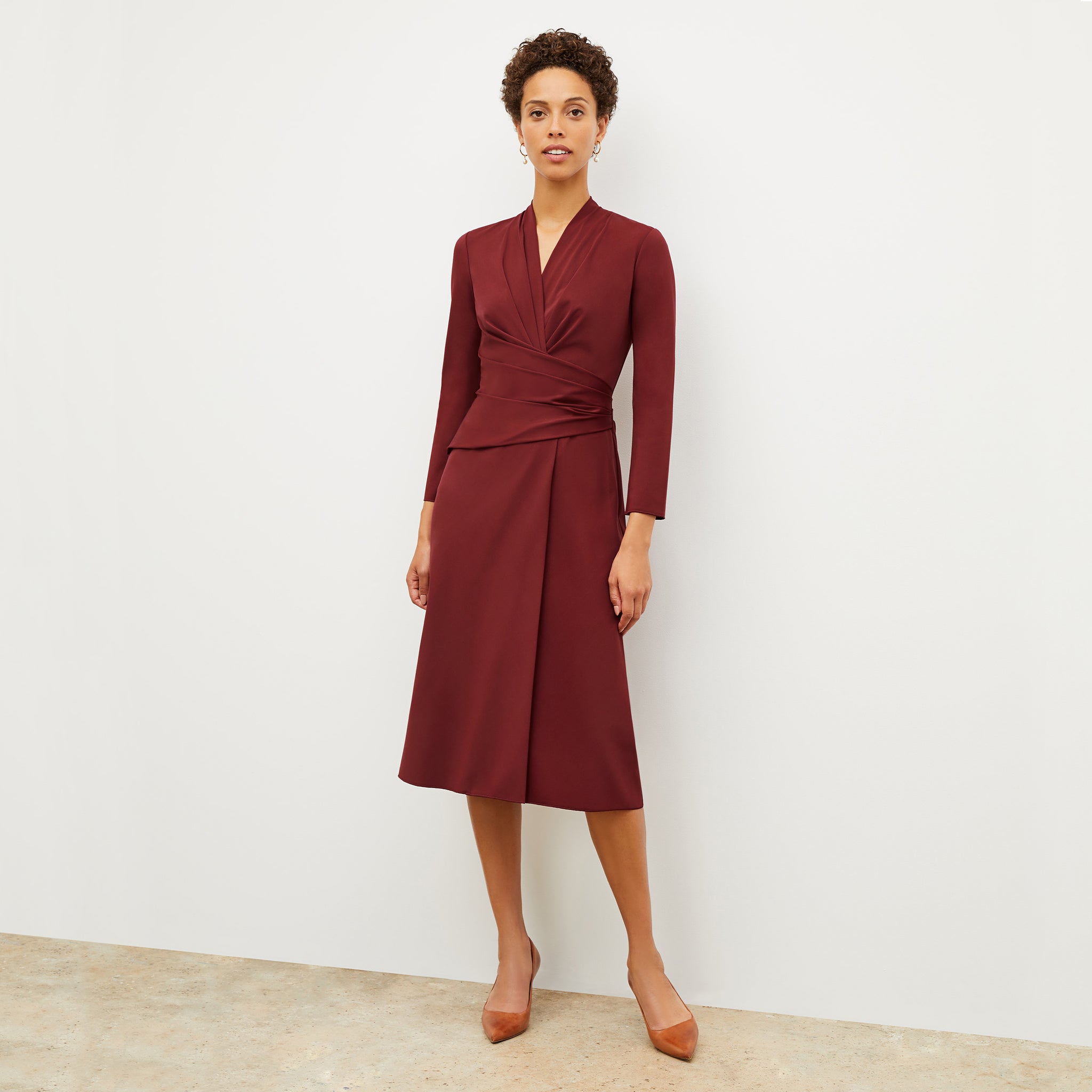 Front image of a woman wearing the carly dress in maroon