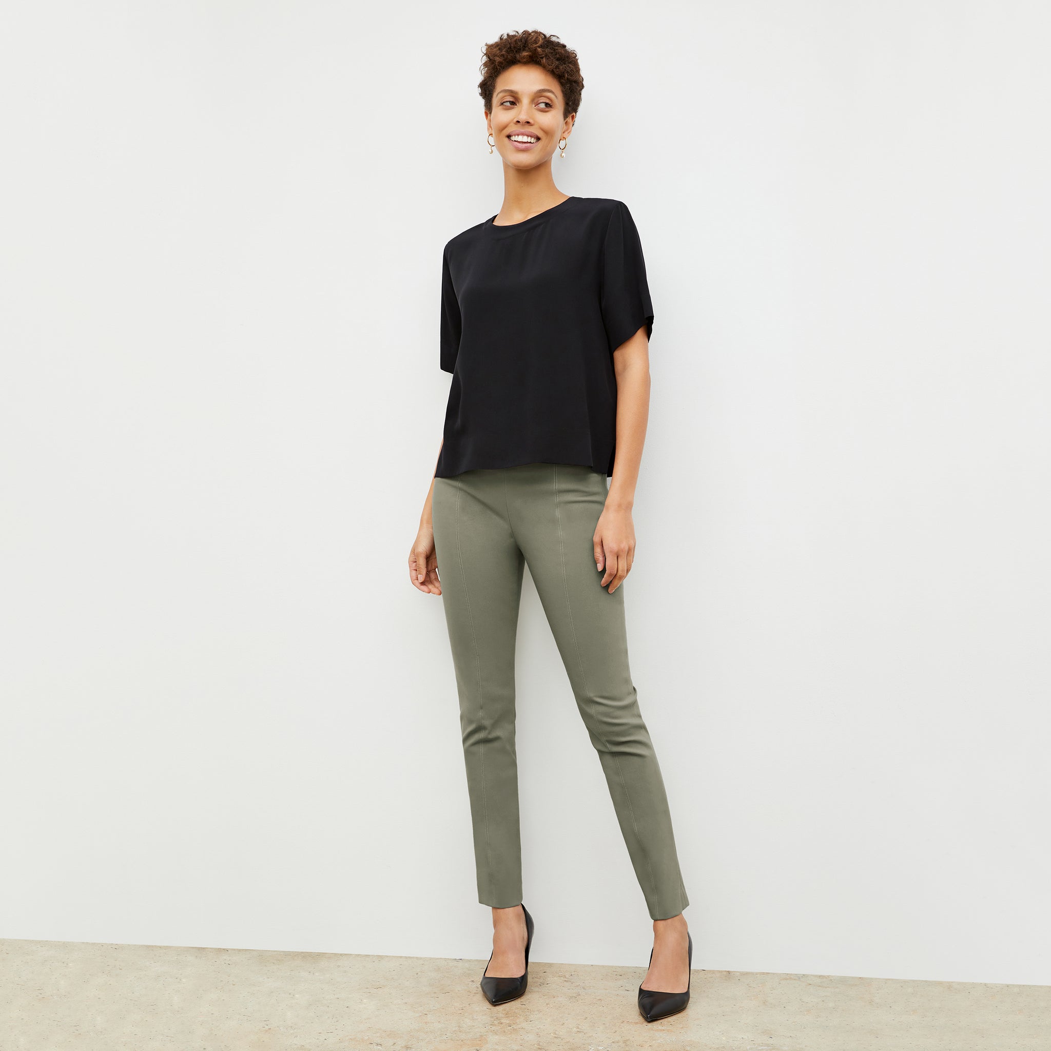 Front image of a woman wearing the foster pant in thyme