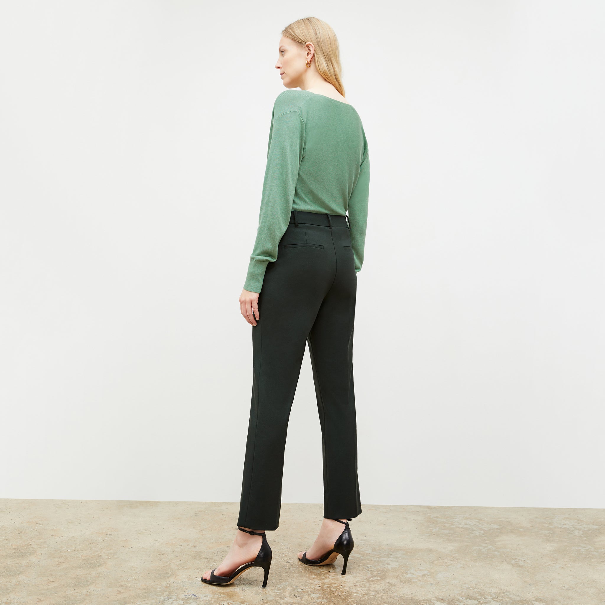 Back image of a woman wearing the monica top in spring green