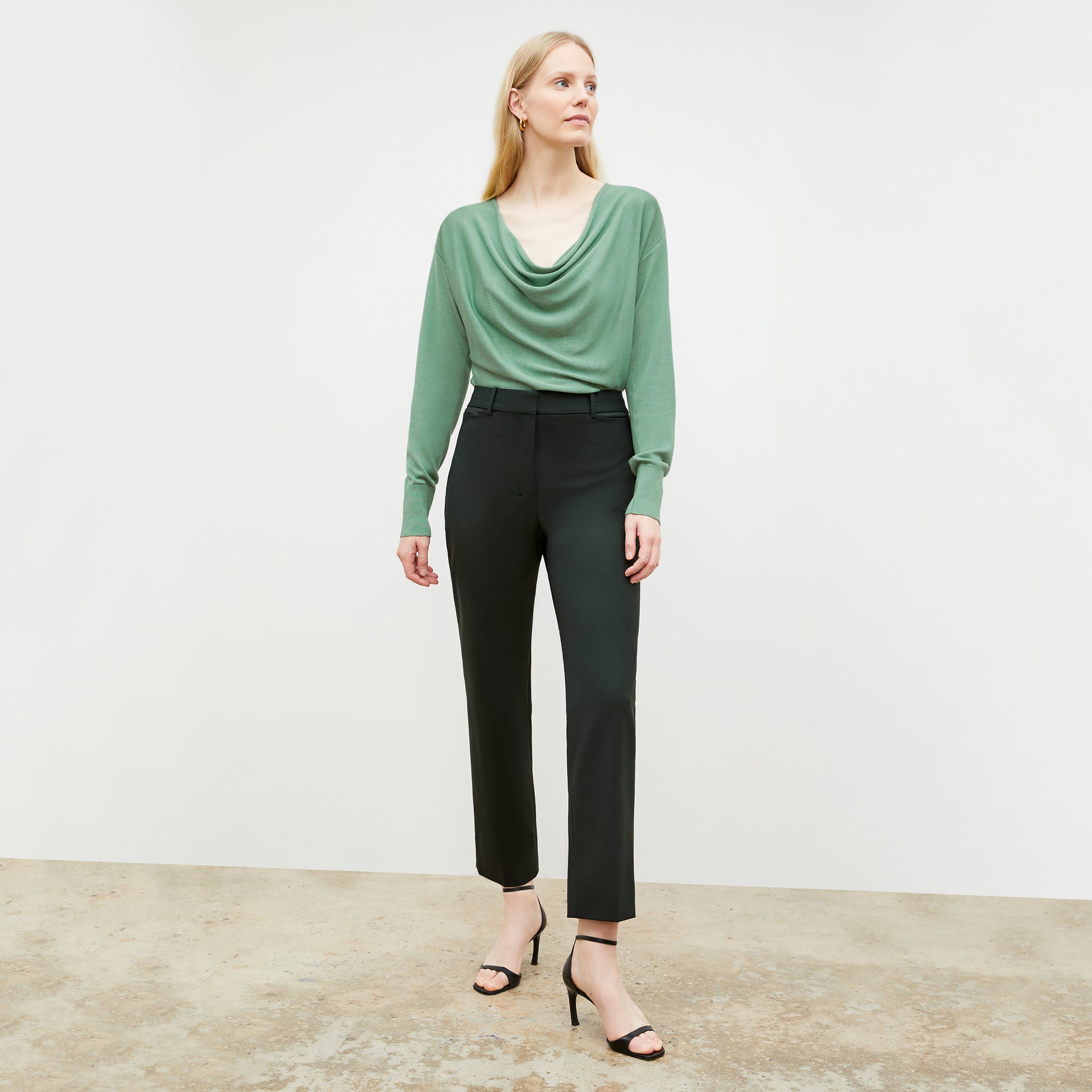 Front image of a woman wearing the monica top in spring green 