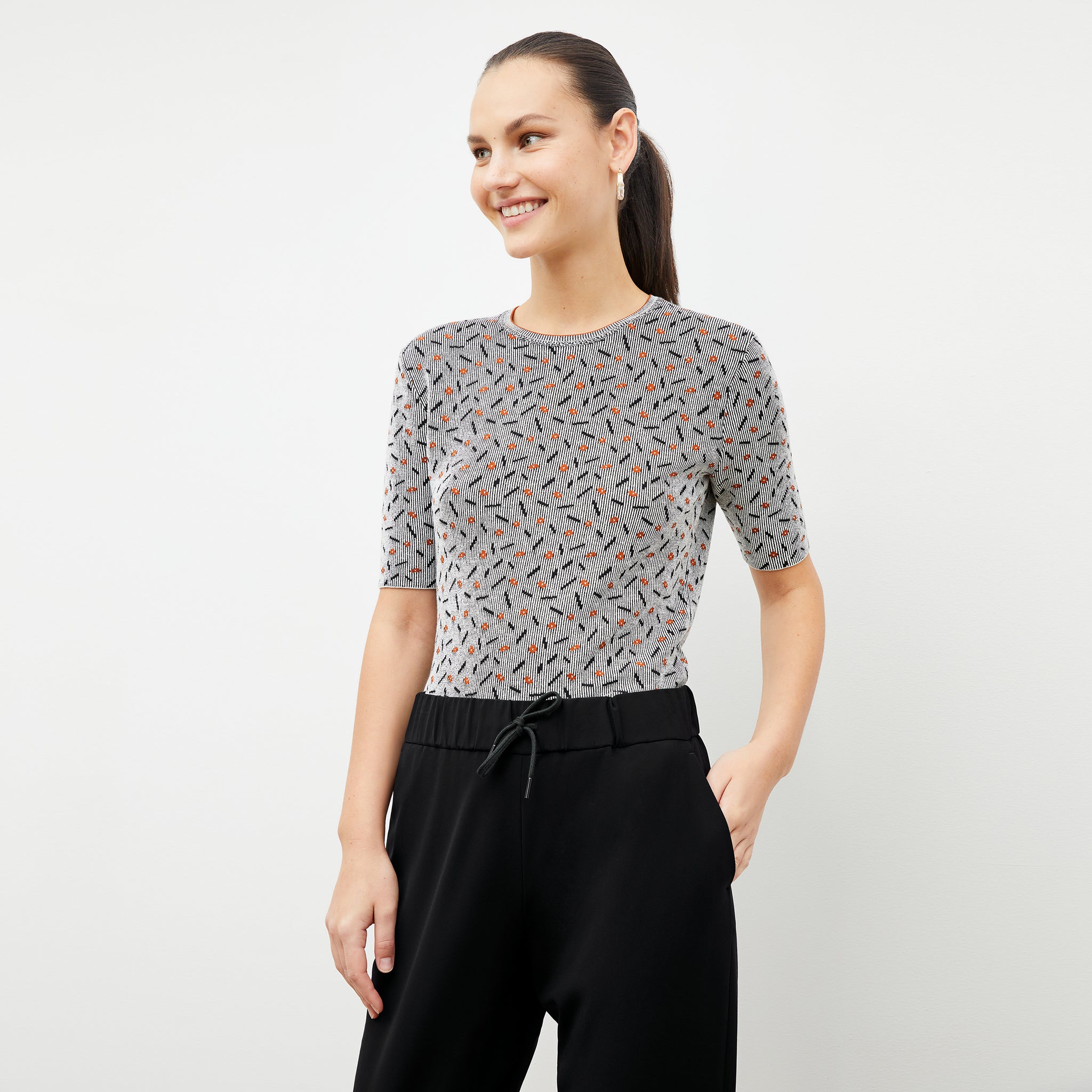 Front image of a woman wearing the Charli Top in Brick and Black 