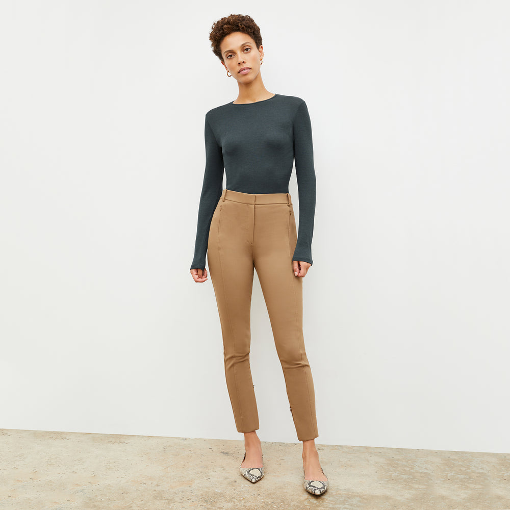 Front image of a woman standing wearing the Curie Pant—Everstretch in Saddle