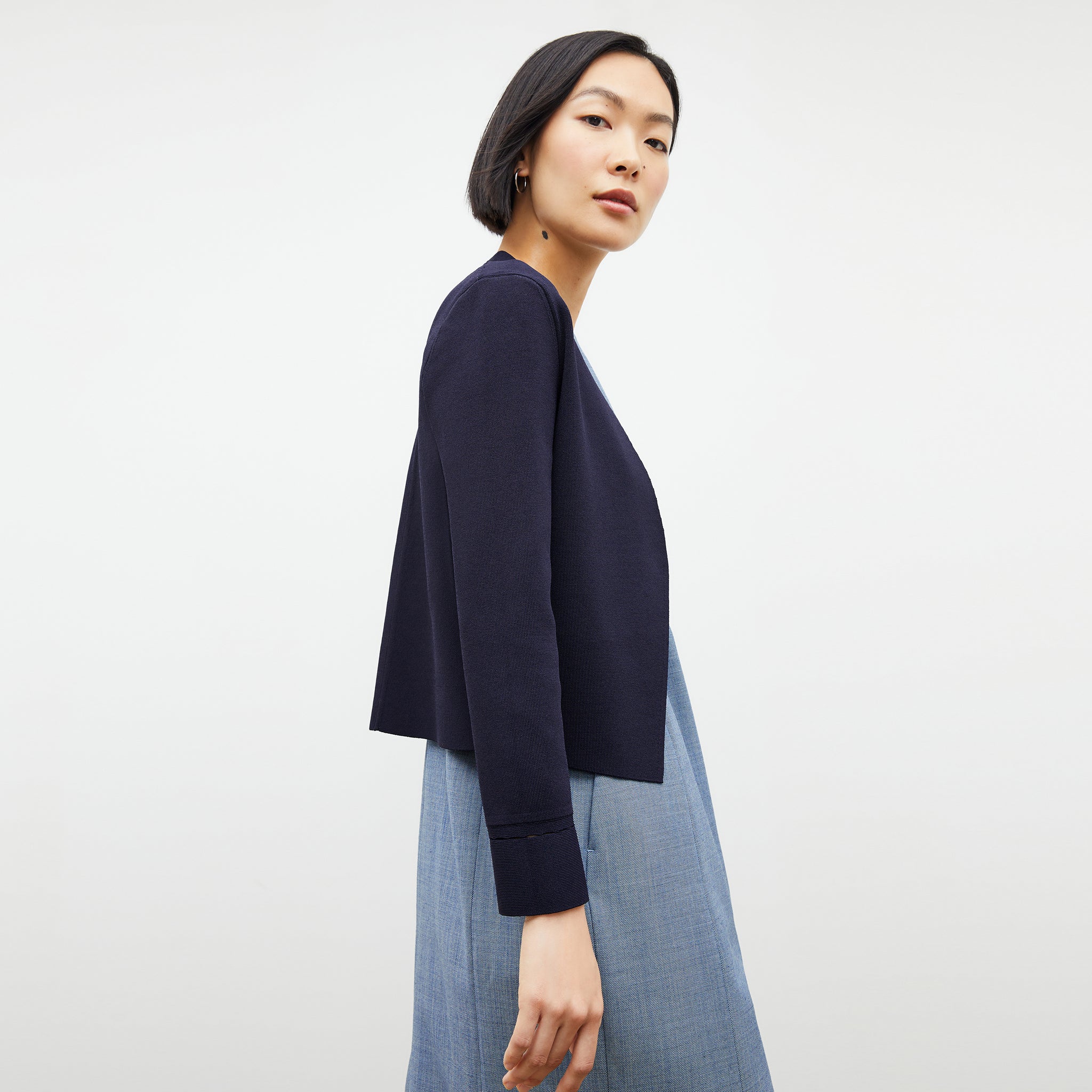 Side image of a woman wearing the constance dress in indigo and white